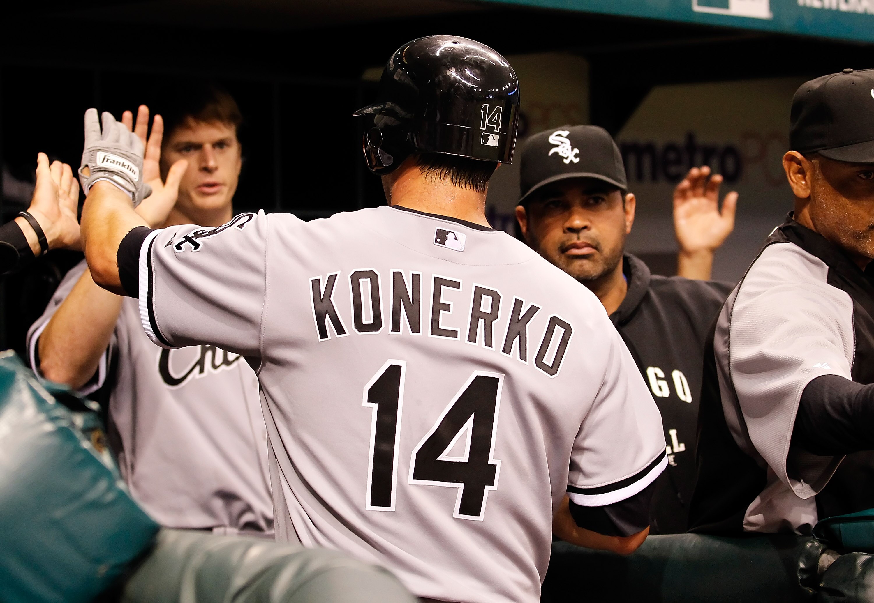 ST. PETERSBURG, FL - APRIL 21:  Infielder Paul Konerko #14 of the Chicago White Sox is congratulated by his teammates after scoring a run against the Tampa Bay Rays during the game at Tropicana Field on April 21, 2011 in St. Petersburg, Florida.  (Photo b