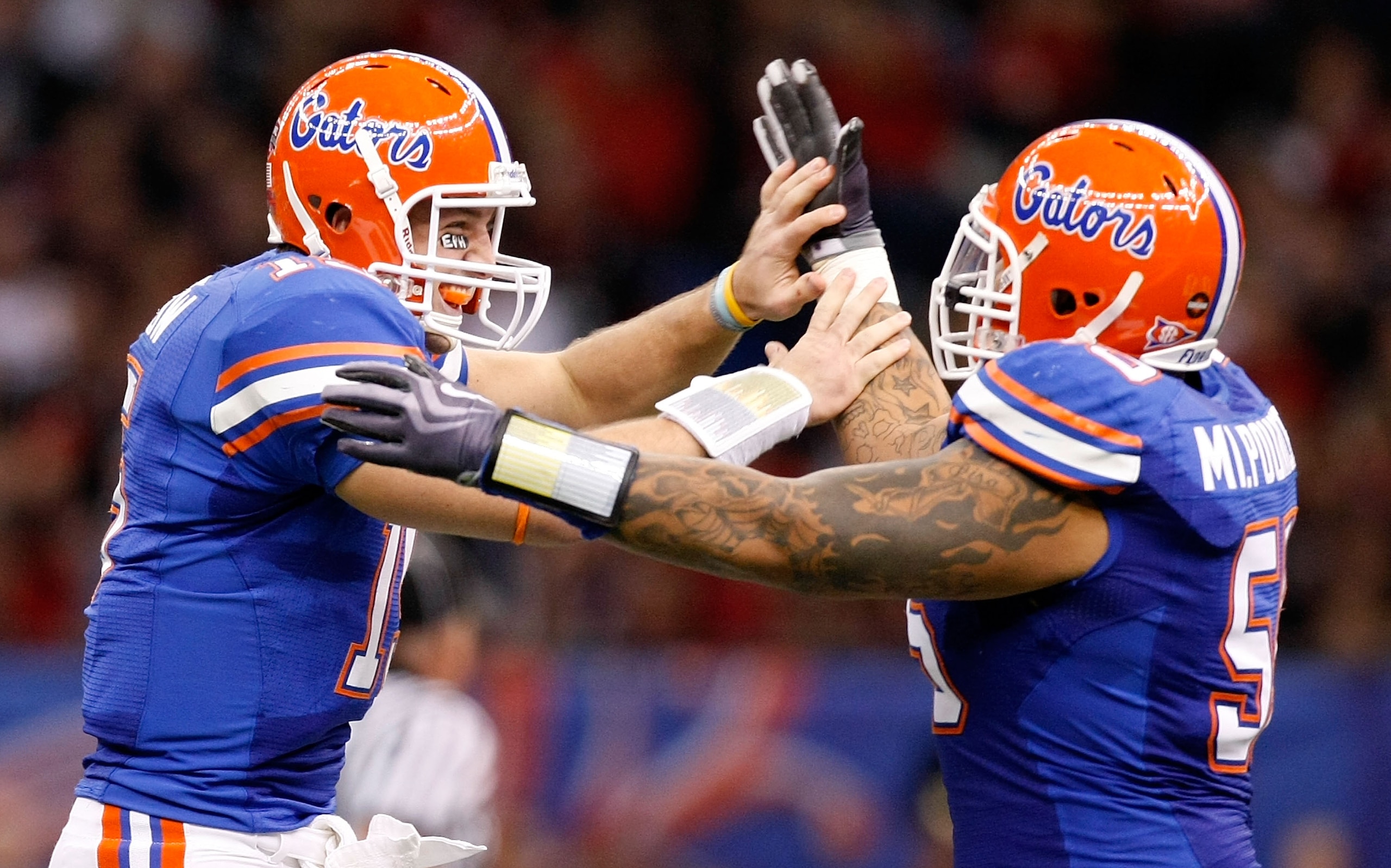 NEW ORLEANS - JANUARY 01: Quarterback Tim Tebow #15 of the Florida Gators celebrates tossing a touchdown pass against the Cincinnati Bearcats with Mike Pouncey #55 during the Allstate Sugar Bowl at the Louisana Superdome on January 1, 2010 in New Orleans NEW ORLEANS - JANUARY 01: Quarterback Tim Tebow #15 of the Florida Gators celebrates tossing a touchdown pass against the Cincinnati Bearcats with Mike Pouncey #55 during the Allstate Sugar Bowl at the Louisana Superdome on January 1, 2010 in New Orleans