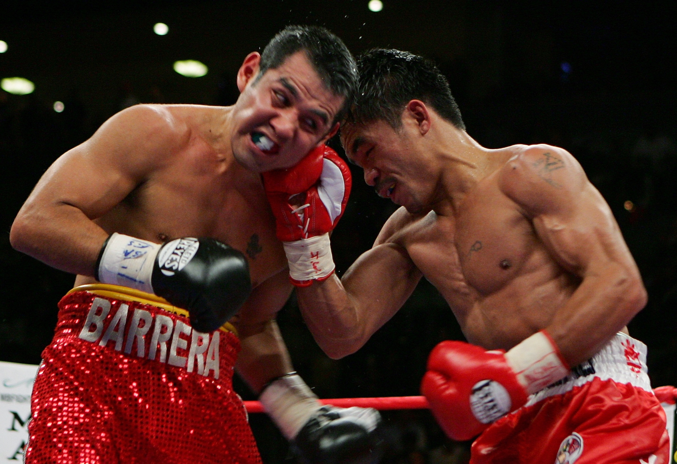 LAS VEGAS - OCTOBER 06:  Manny Pacquiao (R) hits Marco Antonio Barrera during the 11th round of their 12-round super featherweight bout at the Mandalay Bay Events Center October 6, 2007 in Las Vegas, Nevada. Pacquiao won by unanimous decision.  (Photo by