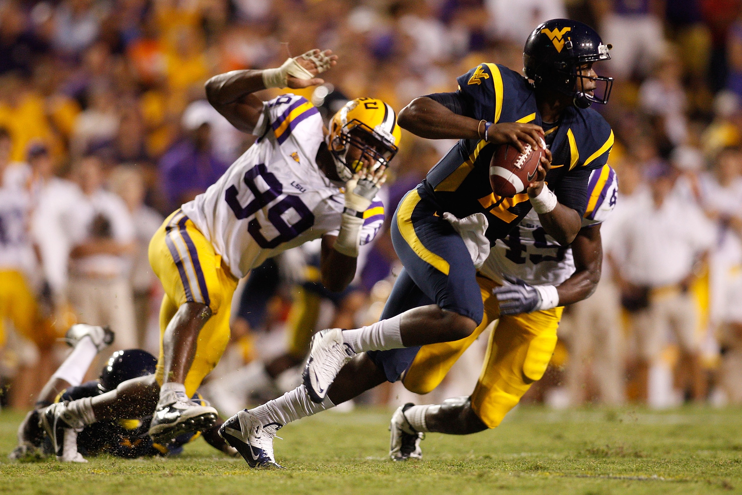 BATON ROUGE, LA - SEPTEMBER 25: Quarterback Geno Smith #12 of the West Virginia Mountaineers in action against the Louisiana State University Tigers at Tiger Stadium on September 25, 2010 in Baton Rouge, Louisiana. (Photo by Chris Graythen/Getty Images) BATON ROUGE, LA - SEPTEMBER 25: Quarterback Geno Smith #12 of the West Virginia Mountaineers in action against the Louisiana State University Tigers at Tiger Stadium on September 25, 2010 in Baton Rouge, Louisiana. (Photo by Chris Graythen/Getty Images)