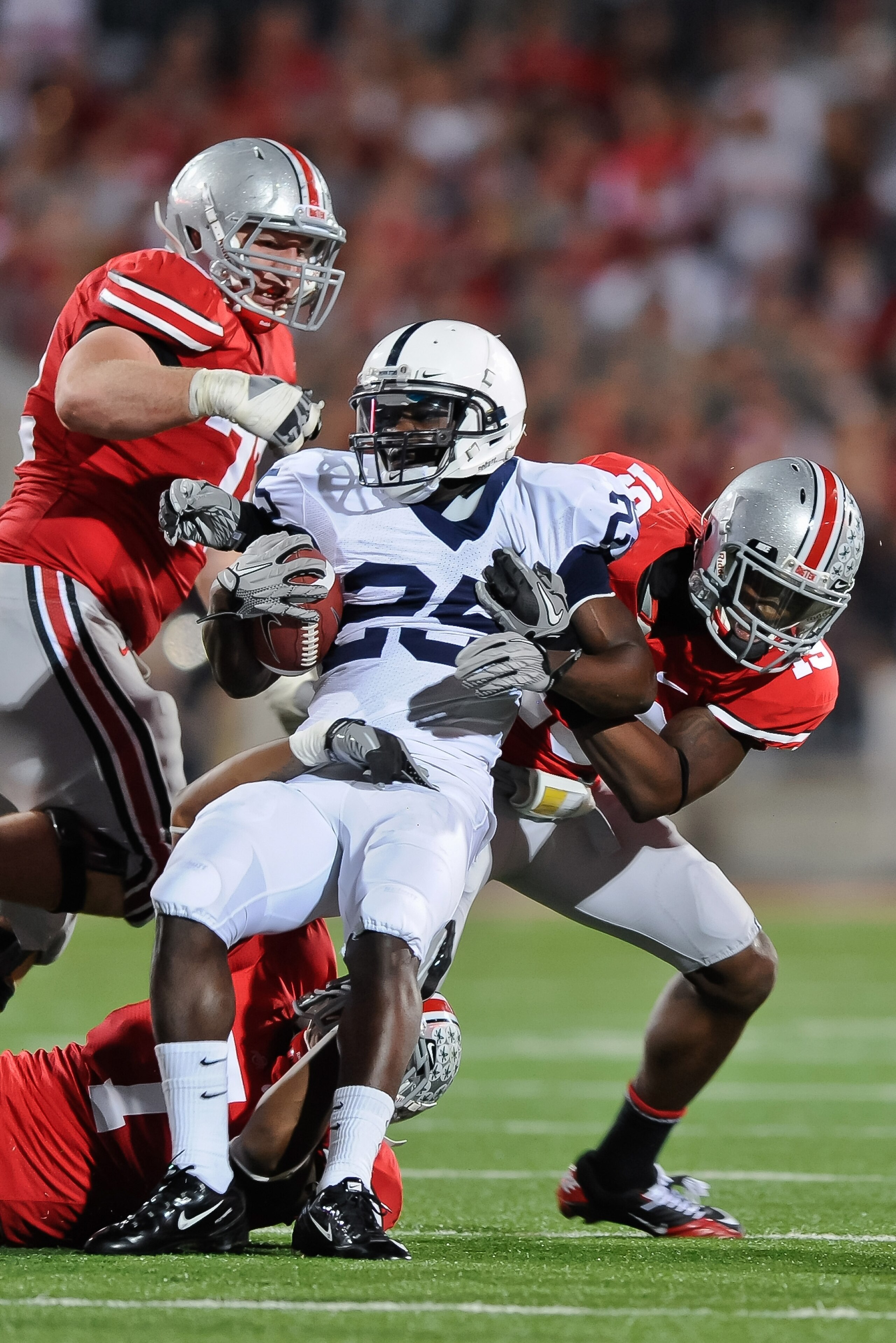 COLUMBUS, OH - NOVEMBER 13: Silas Redd #25 of the Penn State Nittany LIons is tackled by Jermale Hines #7, Orhian Johnson #19 and Dexter Larimore #72, all of the Ohio State Buckeyes at Ohio Stadium on November 13, 2010 in Columbus, Ohio. (Photo by Jamie COLUMBUS, OH - NOVEMBER 13: Silas Redd #25 of the Penn State Nittany LIons is tackled by Jermale Hines #7, Orhian Johnson #19 and Dexter Larimore #72, all of the Ohio State Buckeyes at Ohio Stadium on November 13, 2010 in Columbus, Ohio. (Photo by Jamie