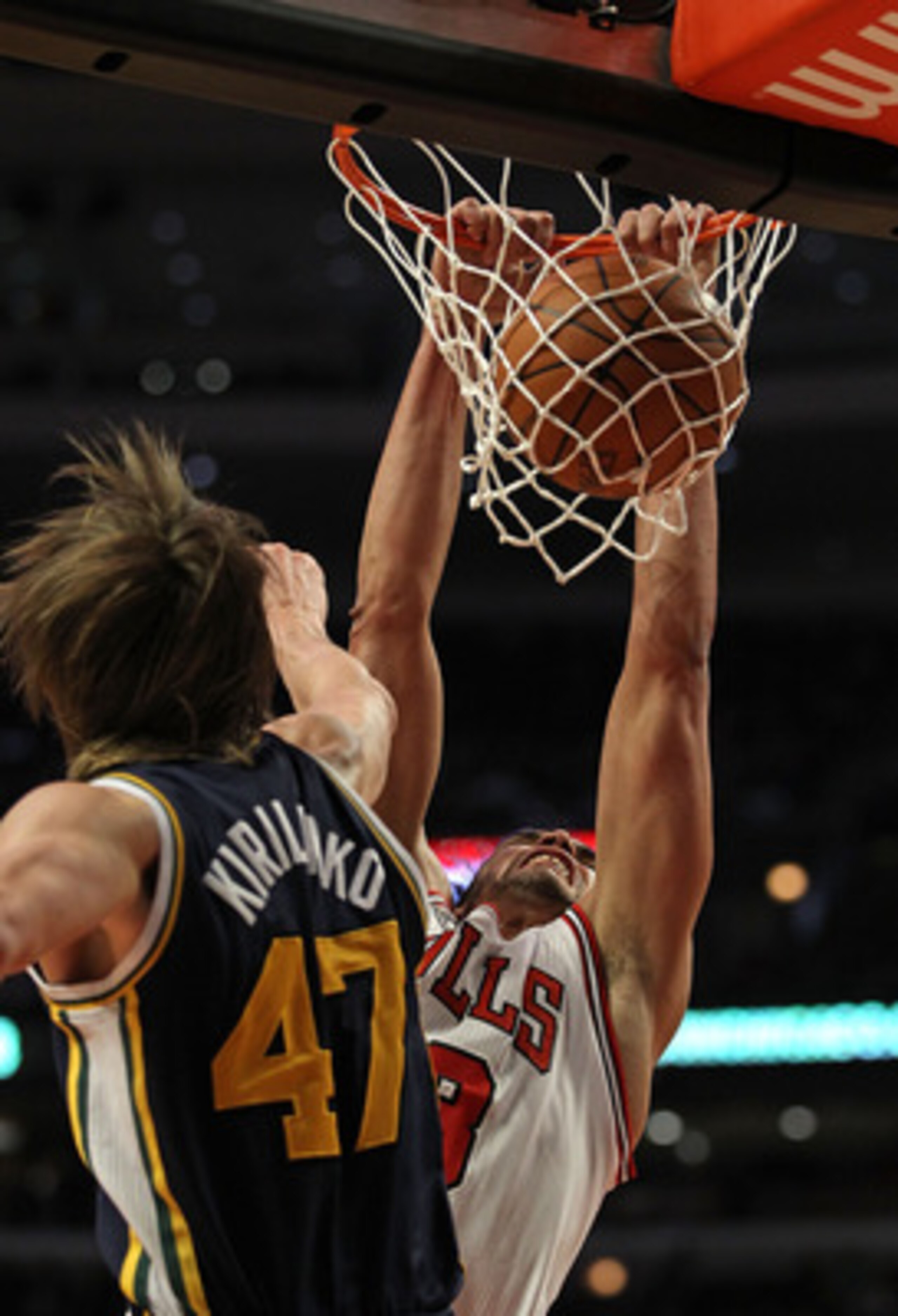 CHICAGO, IL - MARCH 12: Joakim Noah #13 of the Chicago Bulls dunks the ball against Andrei Kirilenko #47 of the Utah Jazz at the United Center on March 12, 2011 in Chicago, Illinois. The Bulls defeated the Jazz 118-100. NOTE TO USER: User expressly acknow