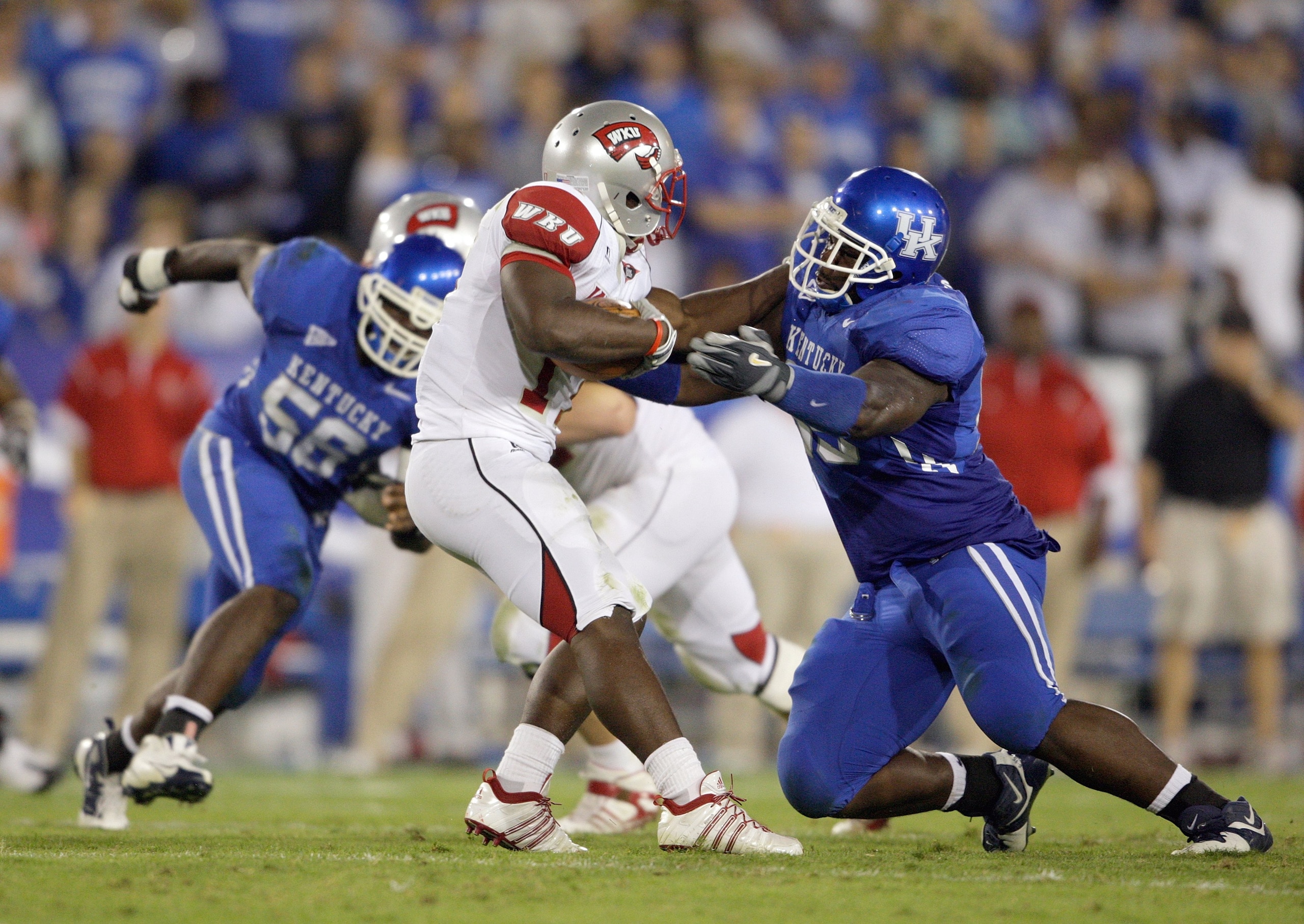 LEXINGTON, KY - SEPTEMBER 27:  Ventrell Jenkins #95 of the Kentucky Wildcats tackles Bobby Rainey #17 of the Western Kentucky Hilltoppers during the game at Commonwealth Stadium on September 27, 2008 in Lexington, Kentucky. The Wildcats defeated the Hillt