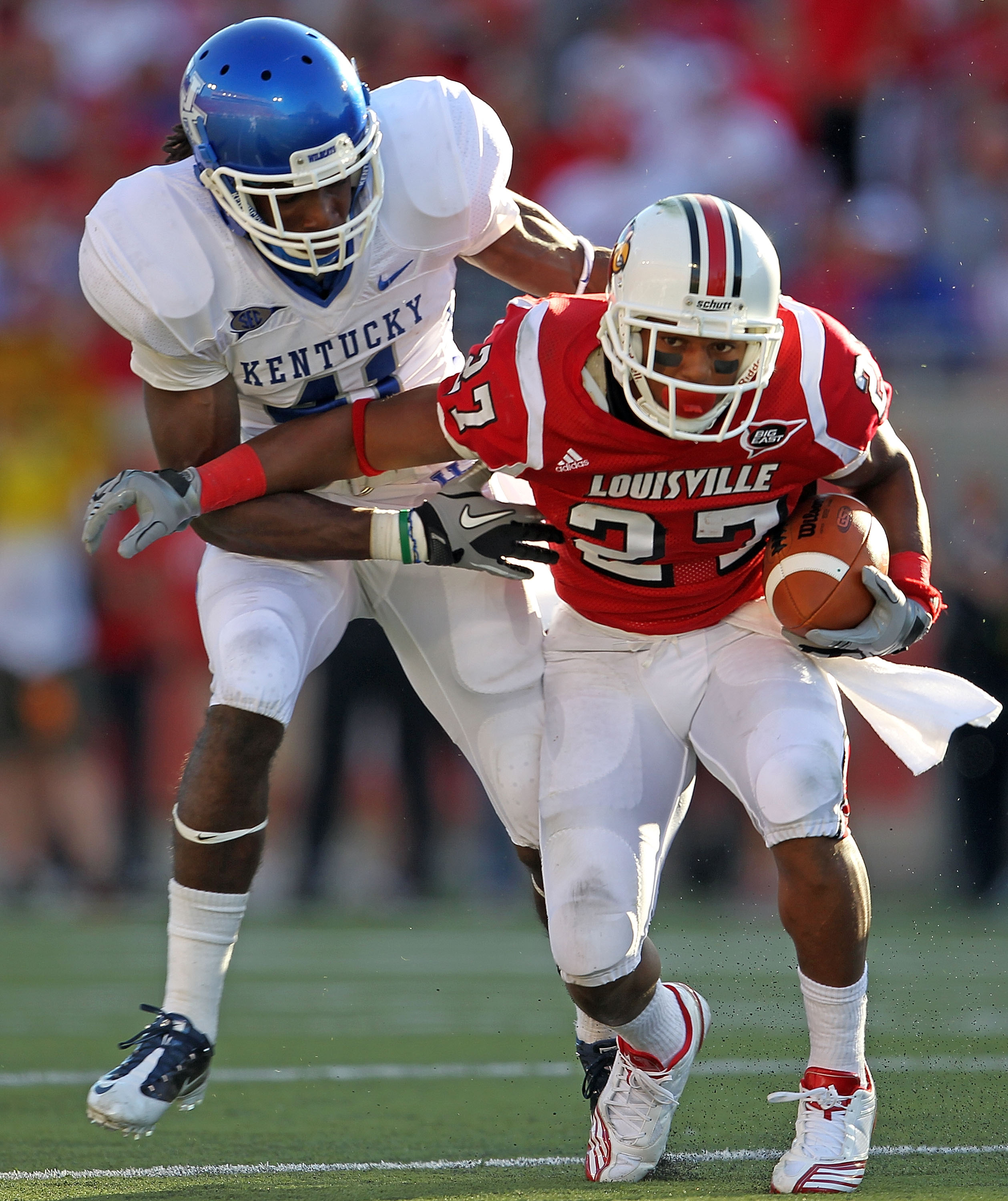 LOUISVILLE, KY - SEPTEMBER 04:  Mychal Bailey #41 of the Kentucky Wildcats tackles Doug Beaumont #27 of the Louisville Cardinals during the game at Papa John's Cardinal Stadium on September 4, 2010 in Louisville, Kentucky.  (Photo by Andy Lyons/Getty Imag