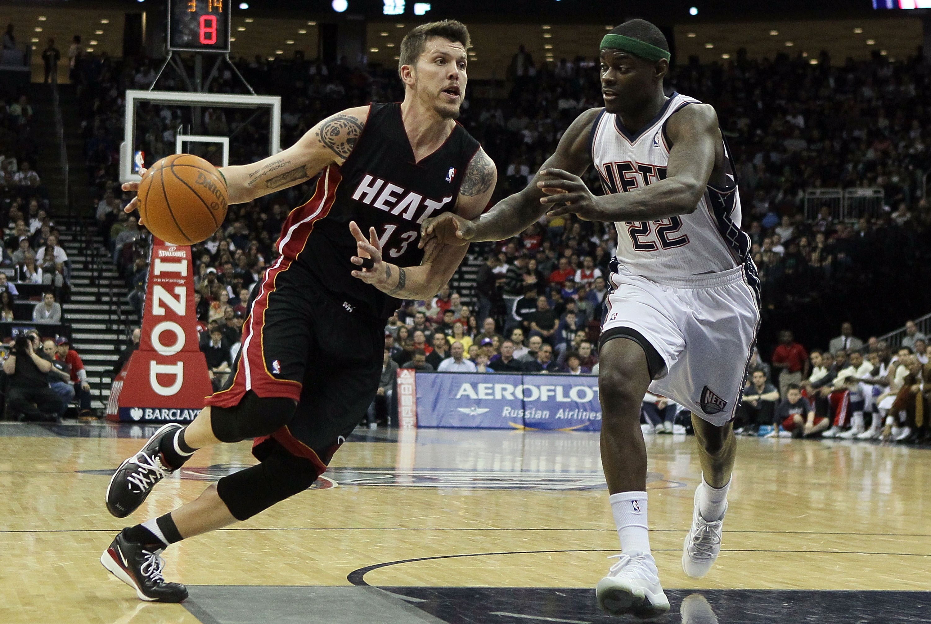 NEWARK, NJ - APRIL 03:  Mike Miller #13 of the Miami Heat drives against Anthony Morrow #22 of the New Jersey Nets at the Prudential Center on April 3, 2011 in Newark, New Jersey.NOTE TO USER: User expressly acknowledges and agrees that, by downloading an