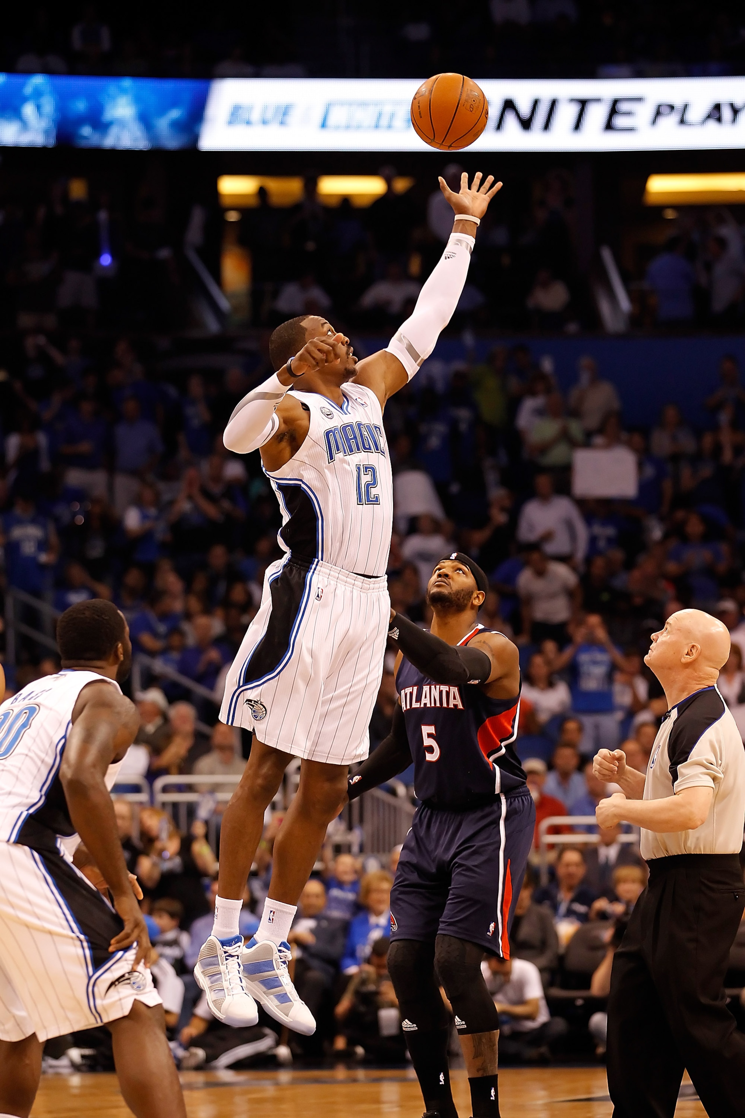 ORLANDO, FL - APRIL 26: Dwight Howard #12 of the Orlando Magic wins the opening tip against the Atlanta Hawks during Game Five of the Eastern Conference Quarterfinals of the 2011 NBA Playoffs on April 26, 2011 at the Amway Arena in Orlando, Florida. NOT ORLANDO, FL - APRIL 26: Dwight Howard #12 of the Orlando Magic wins the opening tip against the Atlanta Hawks during Game Five of the Eastern Conference Quarterfinals of the 2011 NBA Playoffs on April 26, 2011 at the Amway Arena in Orlando, Florida. NOT