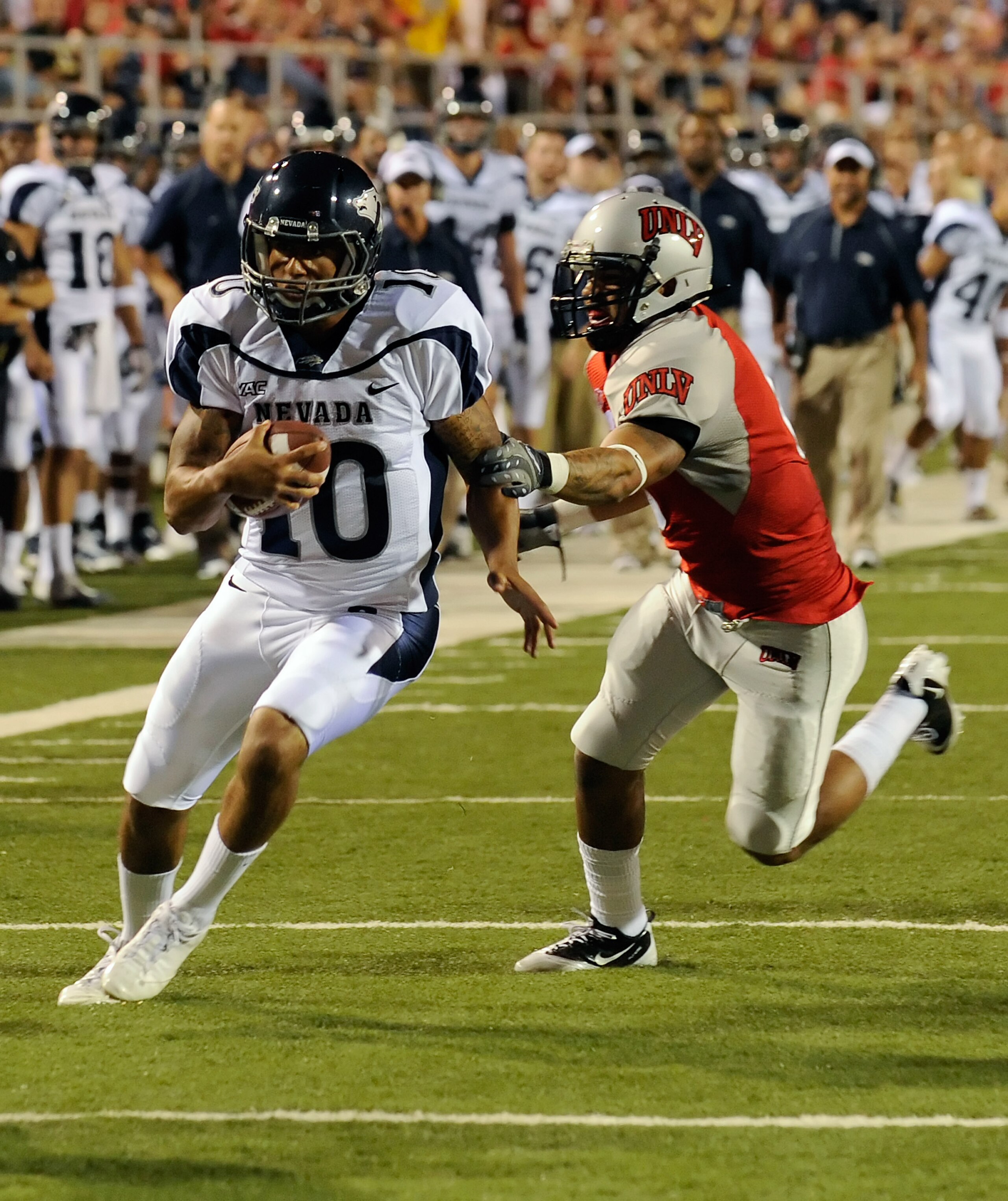 LAS VEGAS - OCTOBER 02: Quarterback Colin Kaepernick #10 of the Nevada Reno Wolf Pack gets away from Mike Clausen #6 of the UNLV Rebel en route to scoring a touchdown in the first quarter of their game at Sam Boyd Stadium October 2, 2010 in Las Vegas, Ne LAS VEGAS - OCTOBER 02: Quarterback Colin Kaepernick #10 of the Nevada Reno Wolf Pack gets away from Mike Clausen #6 of the UNLV Rebel en route to scoring a touchdown in the first quarter of their game at Sam Boyd Stadium October 2, 2010 in Las Vegas, Ne