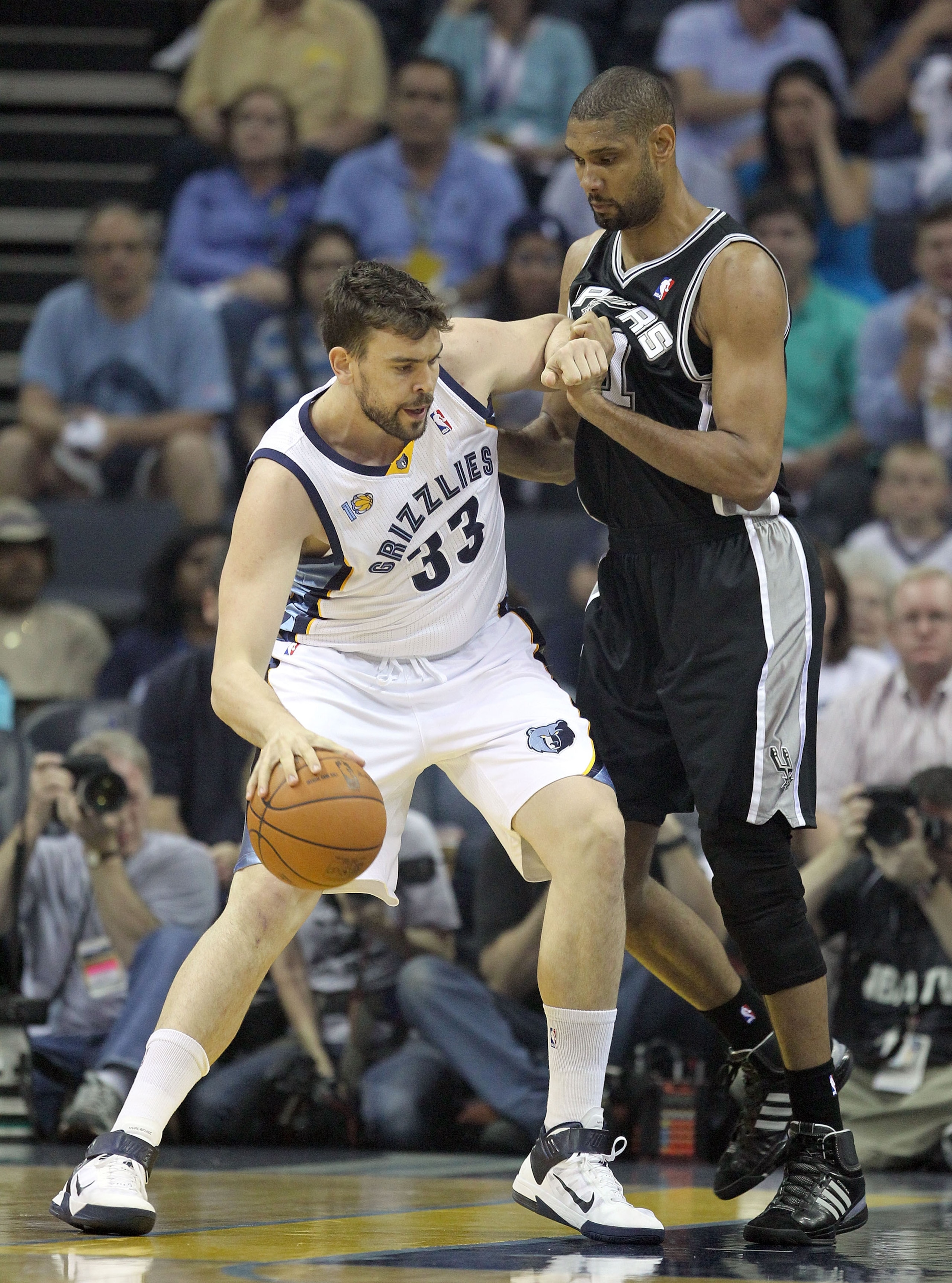 MEMPHIS, TN - APRIL 25: Marc Gasol #33 of the Memphis Grizzlies dribbles the ball while defended by Tim Duncan #21 of the San Antonio Spurs in Game Four of the Western Conference Quarterfinals in the 2011 NBA Playoffs at FedExForum on April 25, 2011 in MEMPHIS, TN - APRIL 25: Marc Gasol #33 of the Memphis Grizzlies dribbles the ball while defended by Tim Duncan #21 of the San Antonio Spurs in Game Four of the Western Conference Quarterfinals in the 2011 NBA Playoffs at FedExForum on April 25, 2011 in