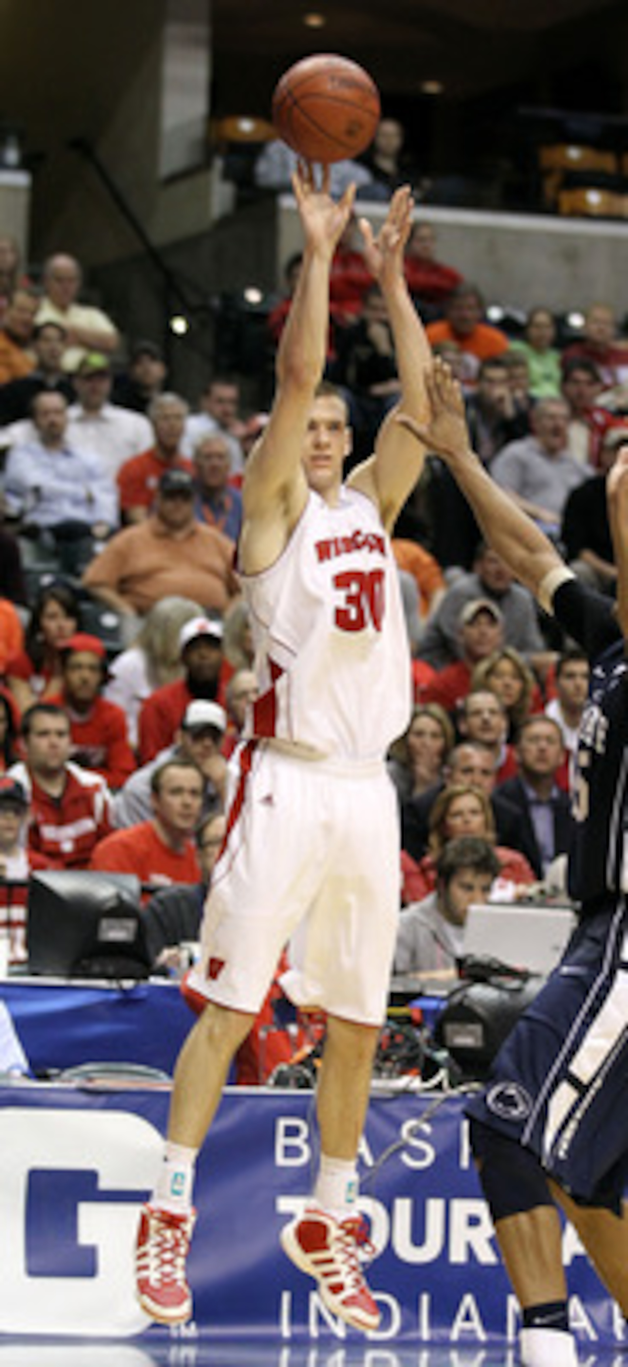 INDIANAPOLIS, IN - MARCH 11:  Jon Leuer #30 of the Wisconsin Badgers attempts a shot against the Penn State Nittany Lions during the quarterfinals of the 2011 Big Ten Men's Basketball Tournament at Conseco Fieldhouse on March 11, 2011 in Indianapolis, Ind
