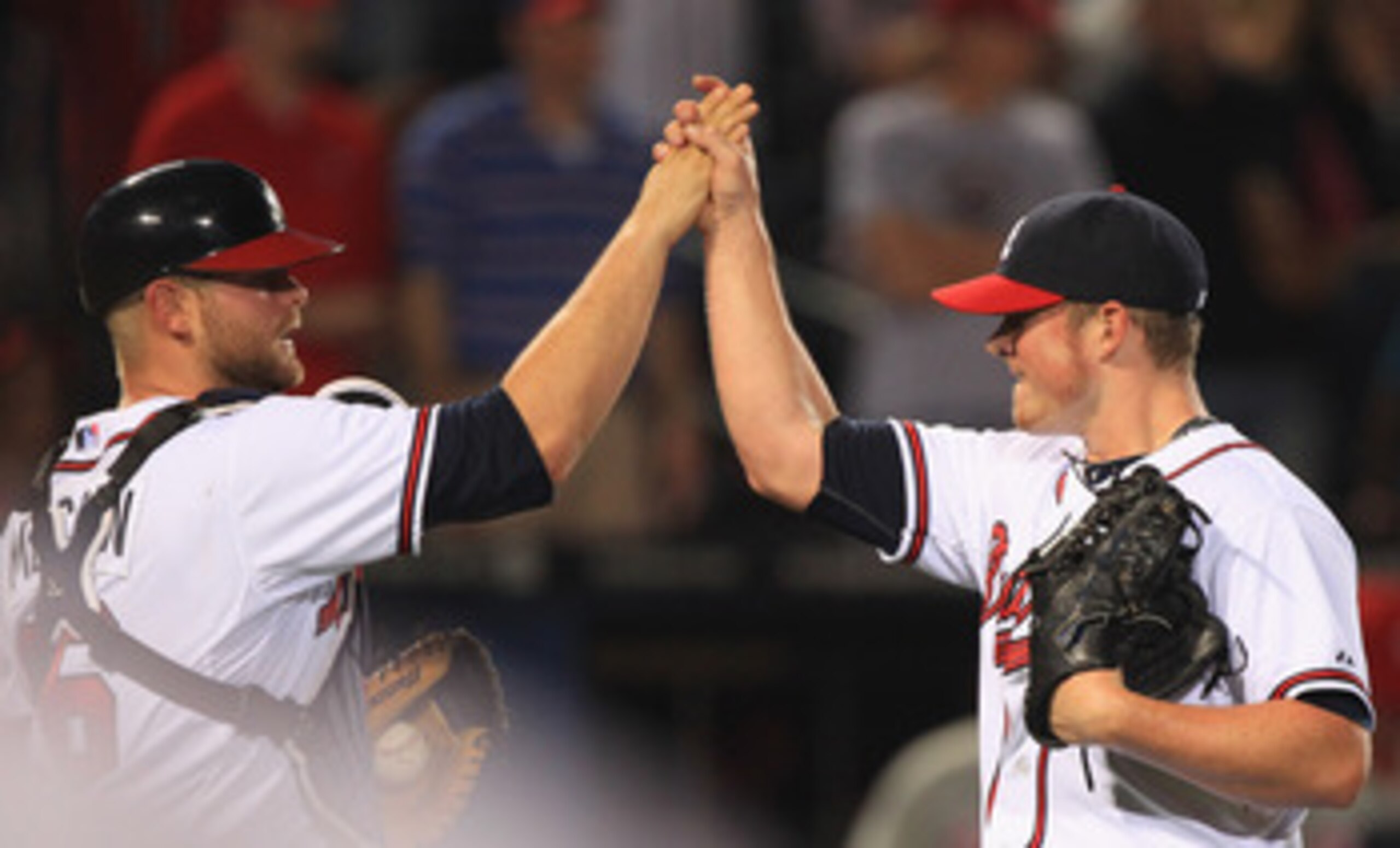 ATLANTA, GA - APRIL 08:  Teammates Brian McCann #16 and Craig Kimbrel #46 of the Atlanta Braves celebrate after a 6-3 victory on their opening day game against the Philadelphia Phillies at Turner Field on April 8, 2011 in Atlanta, Georgia.  (Photo by Stre