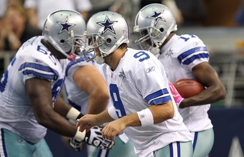 ARLINGTON, TX - OCTOBER 10:  Quarterback Tony Romo #9 of the Dallas Cowboys celebrates a touchdown by Roy Williams #11 against the  Tennessee Titans at Cowboys Stadium on October 10, 2010 in Arlington, Texas.  (Photo by Ronald Martinez/Getty Images)