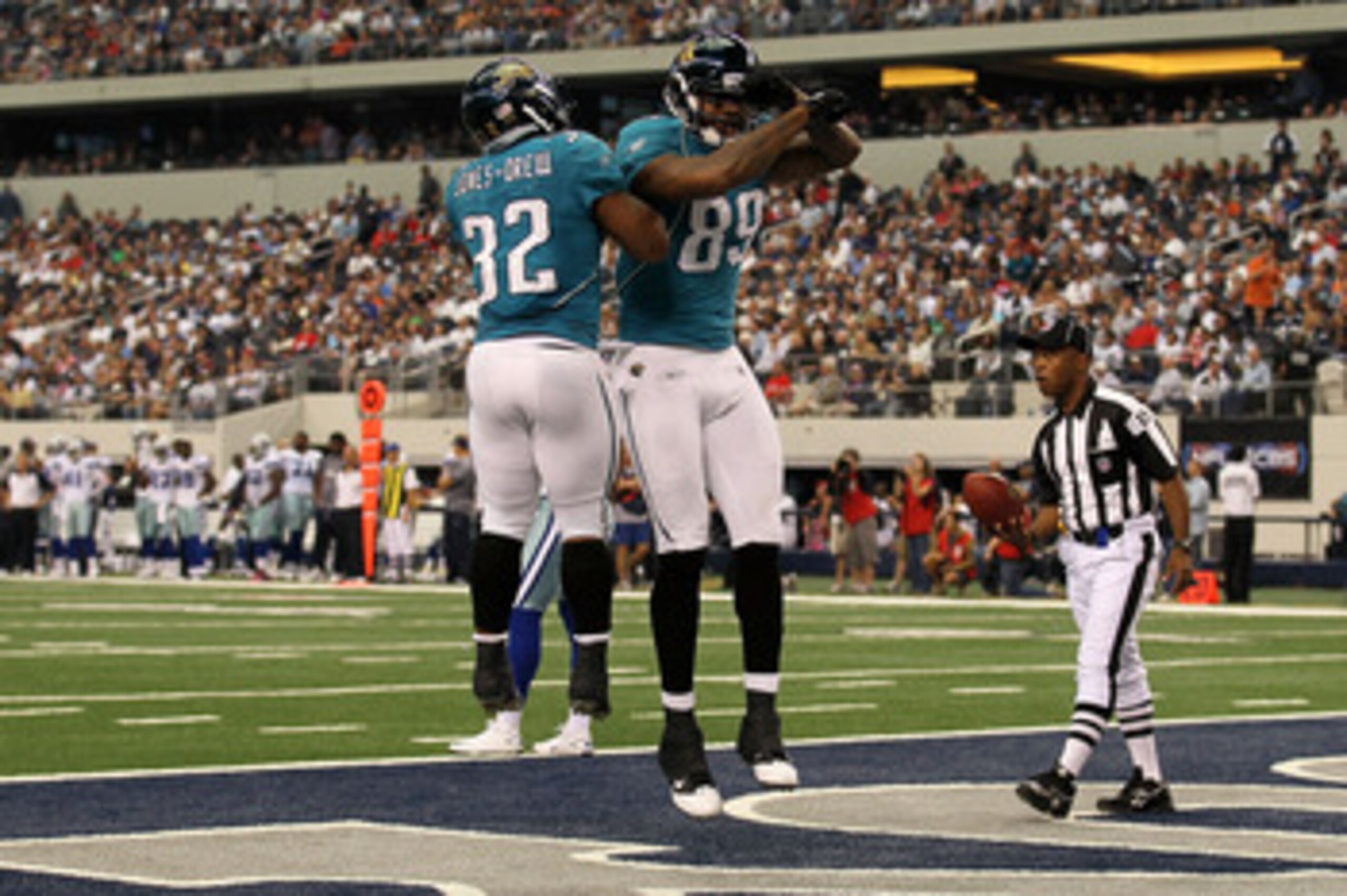 ARLINGTON, TX - OCTOBER 31:  (L-R) Maurice Jones-Drew #32 of the Jacksonville Jaguars #32 and Marcedes Lewis #89 of celebrate after Lewis scored a 42 yard touchdown reception in the first half against the Dallas Cowboys at Cowboys Stadium on October 31, 2