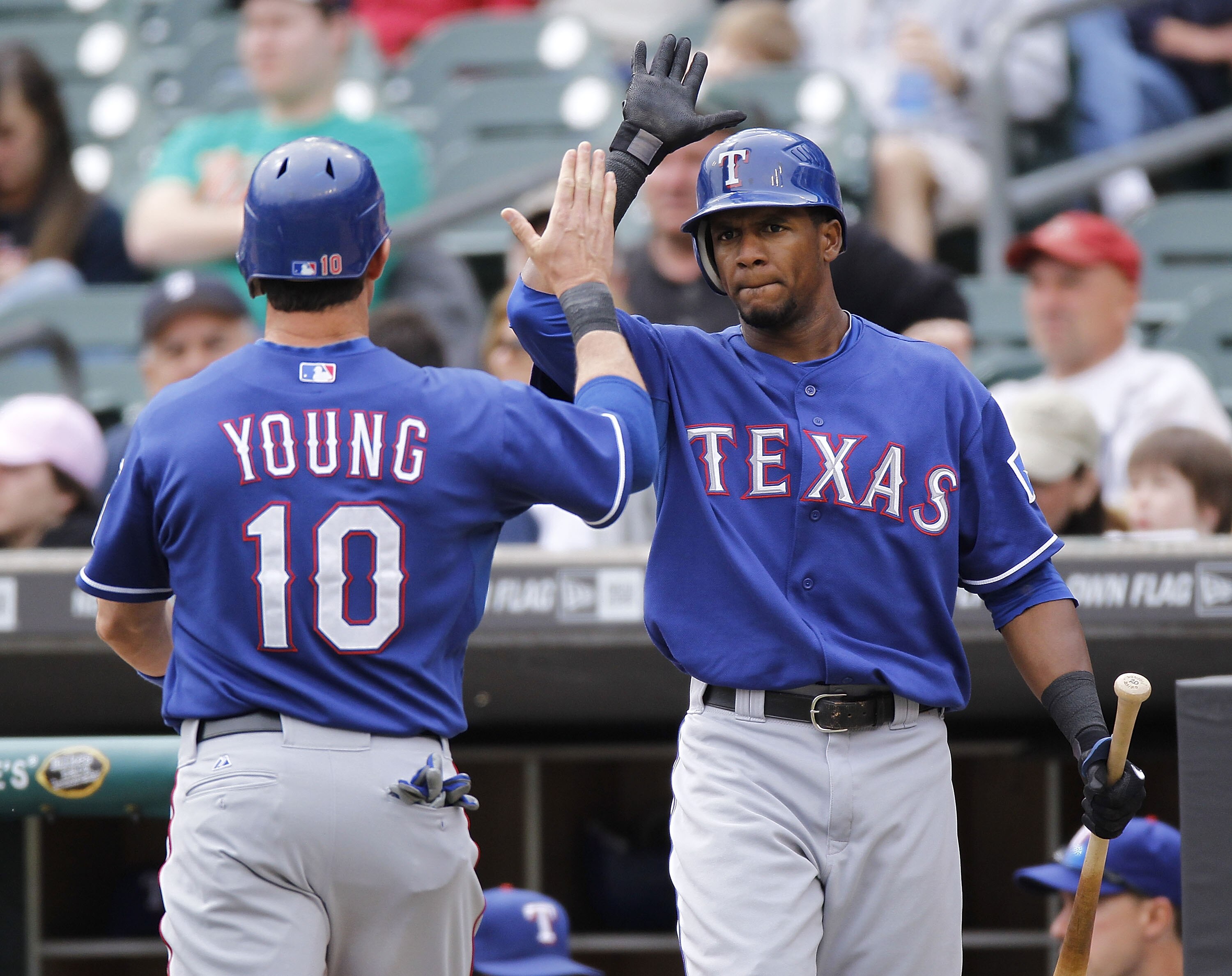 DETROIT, MI - APRIL 11:  Michael Young #10 of the Texas Rangers celebrates scoring a run in the seventh inning with Julio Borbon #20 while playing the Detroit Tigers at Comerica Park on April 11, 2011 in Detroit, Michigan. Texas won the game 2-0. (Photo b