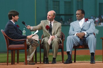 BOSTON - JULY 22:  Former Red Sox pitcher Earl Wilson (R) and broadcaster Sean McDonough (C) listen to baseball historian and filmmaker Ken Burns (L) share historical perspective on Ted Williams during the Ted Williams tribute on July 22, 2002 at Fenway P