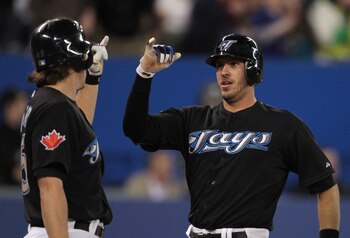 TORONTO, ON - APRIL 20:  J.P. Arencibia #9 of the Toronto Blue Jays (R) celebrates his home run in the second inning with Travis Snider #45 during their game with the New York Yankees at Rogers Centre on April 20, 2011 in Toronto, Canada.  (Photo by Scott