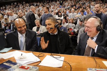 WASHINGTON - JANUARY 30:  President of the United States Barack Obama (C) talks to CBS annoucers Clark Kellogg and Verne Lundquist during a college basketball game between Georgetown Hoyas and the Duke Blue Devils on January 30, 2010 at the Verizon Center