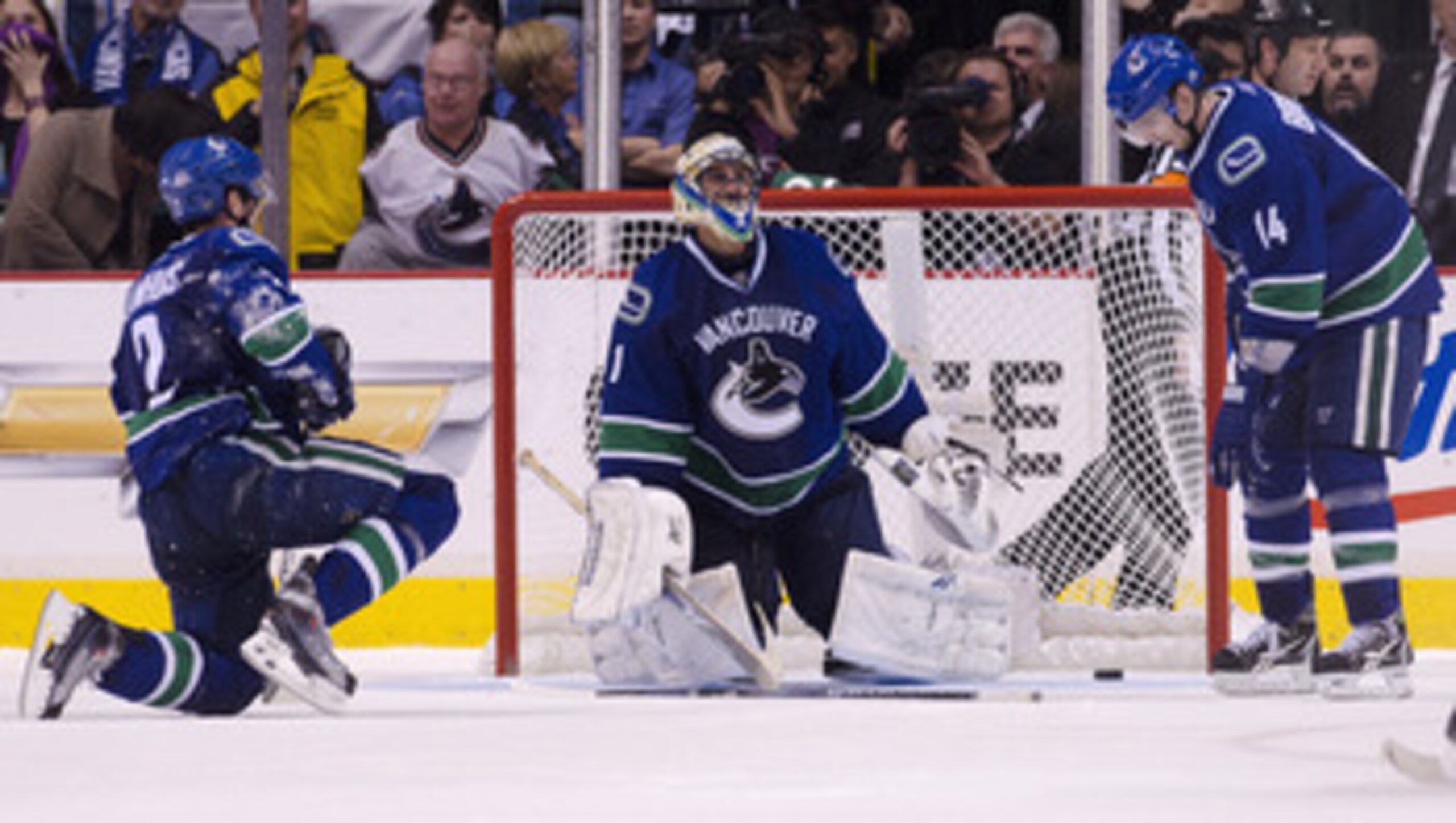 VANCOUVER, CANADA - APRIL 26: Dan Hamhuis #2, goalie Roberto Luongo #1 and Alexandre Burrows #14 of the Vancouver Canucks sit dejectedly on the ice after Jonathan Toews #19 of the Chicago Blackhawks (not pictured) scored the game tieing goal during the th