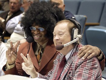 CHAPEL HILL, NC - FEBRUARY 16:  ESPN television announcers Len Elmore (L) and Mike Patrick pose for pictures dressed in 1980s clothing before the start of a retro night game between the Virginia Cavaliers and the North Carolina Tar Heels in an Atlantic Co