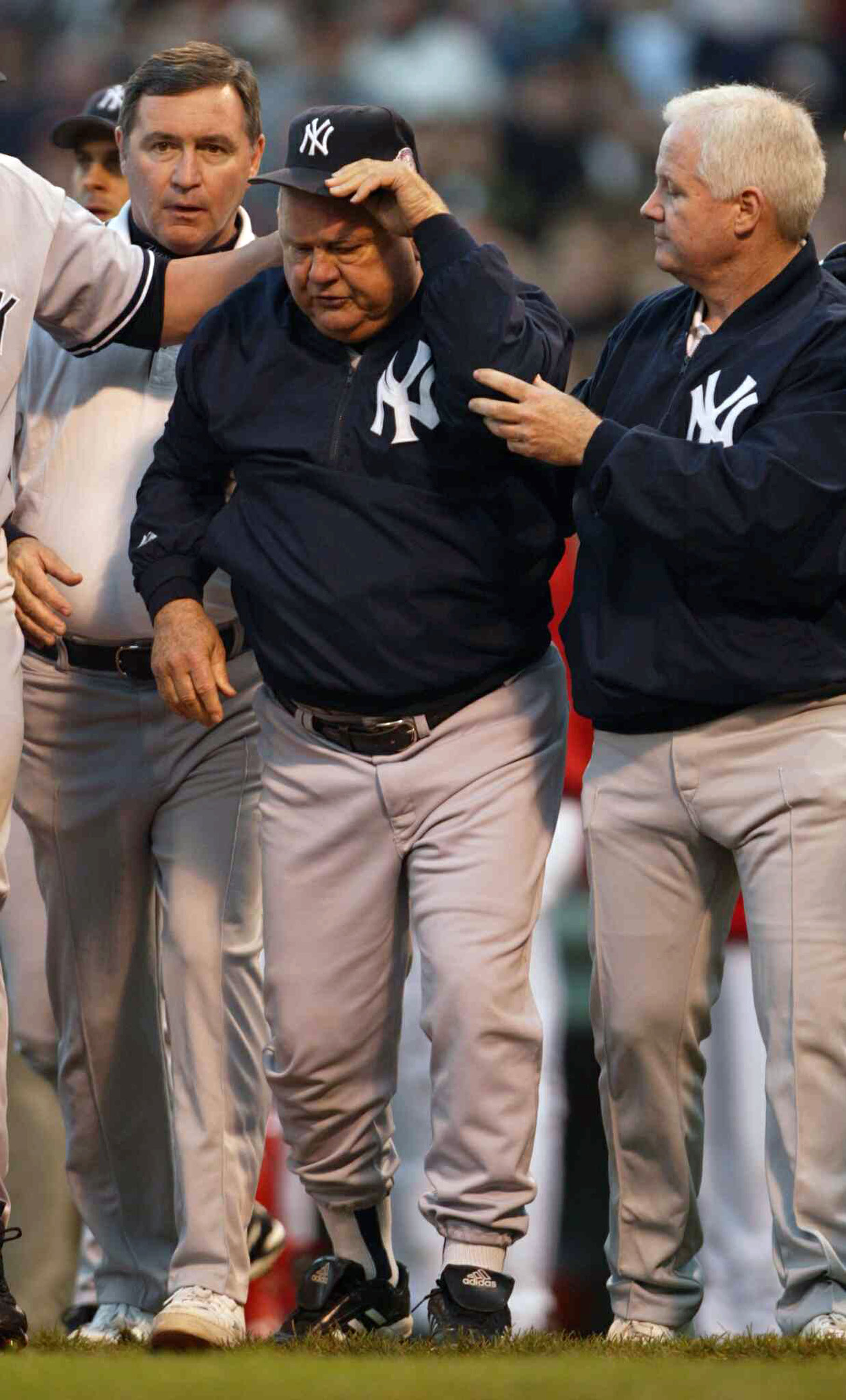 BOSTON - OCTOBER 11:  Bench coach Don Zimmer of the New York Yankees walks off the field after being thrown on the ground by Pedro Martinez #45 of the Boston Red Sox after he thought a pitch was thrown at him during Game 3 of the 2003 American League Cham
