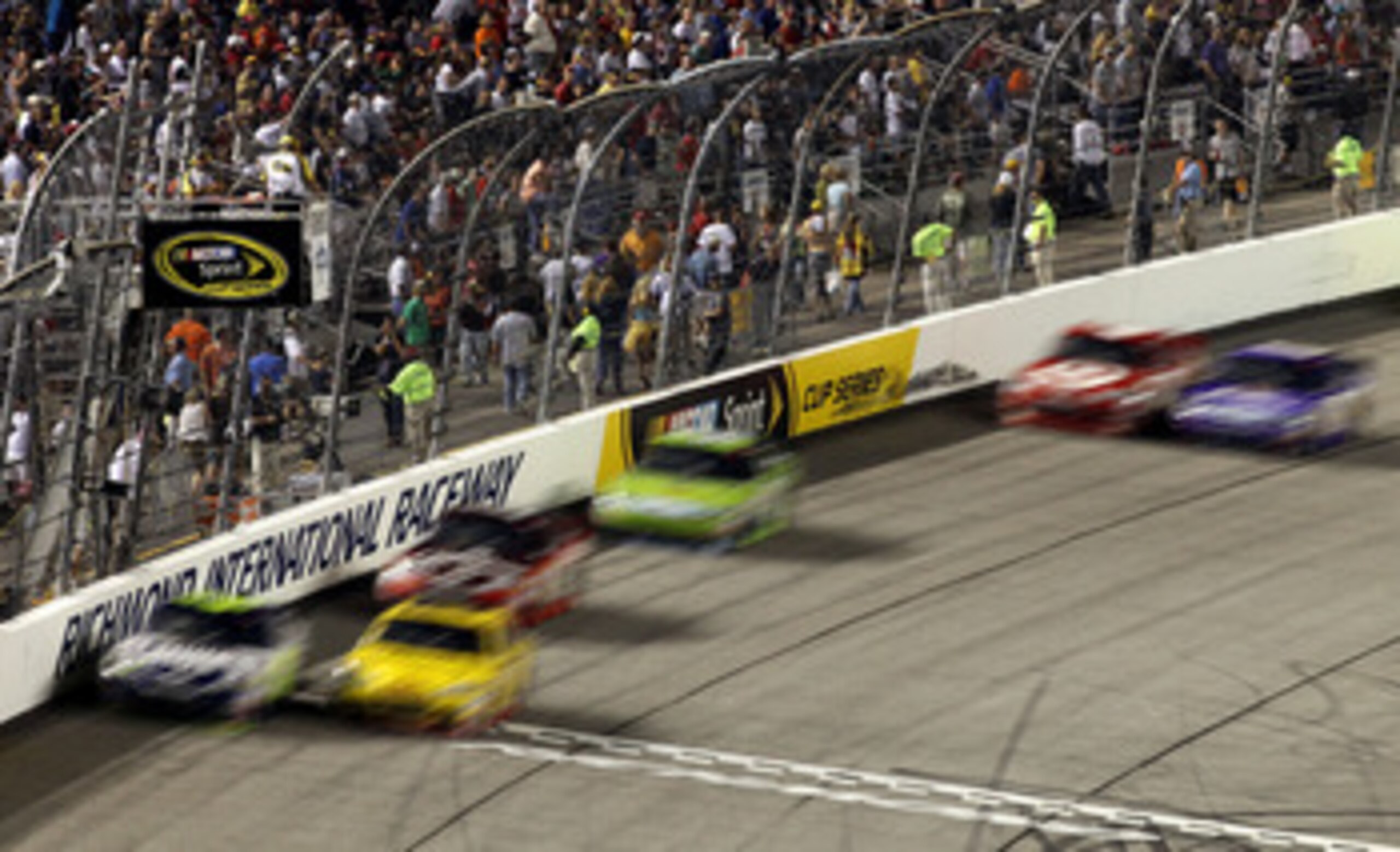 RICHMOND, VA - SEPTEMBER 11:  Denny Hamlin, driver of the #11 FedEx Office Toyota, and Clint Bowyer, driver of the #33Cheerios/Hamburger Helper Chevrolet, lead the field during the NASCAR Sprint Cup Series Air Guard 400 at Richmond International Raceway o