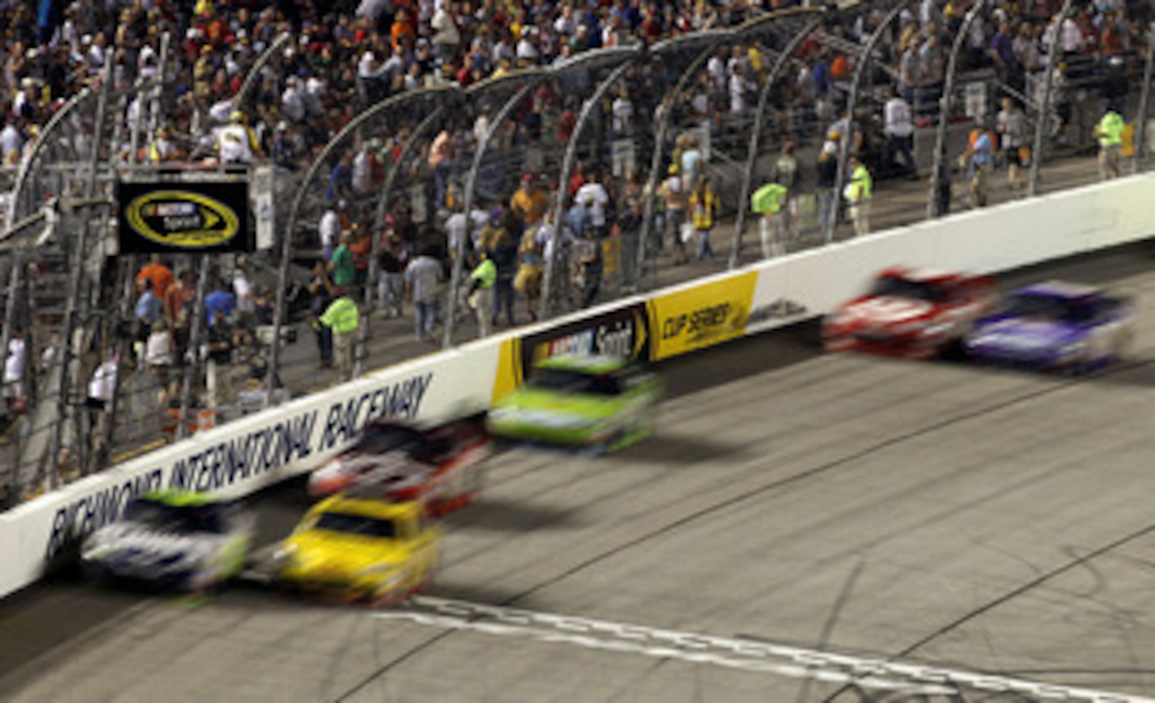 RICHMOND, VA - SEPTEMBER 11:  Denny Hamlin, driver of the #11 FedEx Office Toyota, and Clint Bowyer, driver of the #33Cheerios/Hamburger Helper Chevrolet, lead the field during the NASCAR Sprint Cup Series Air Guard 400 at Richmond International Raceway o