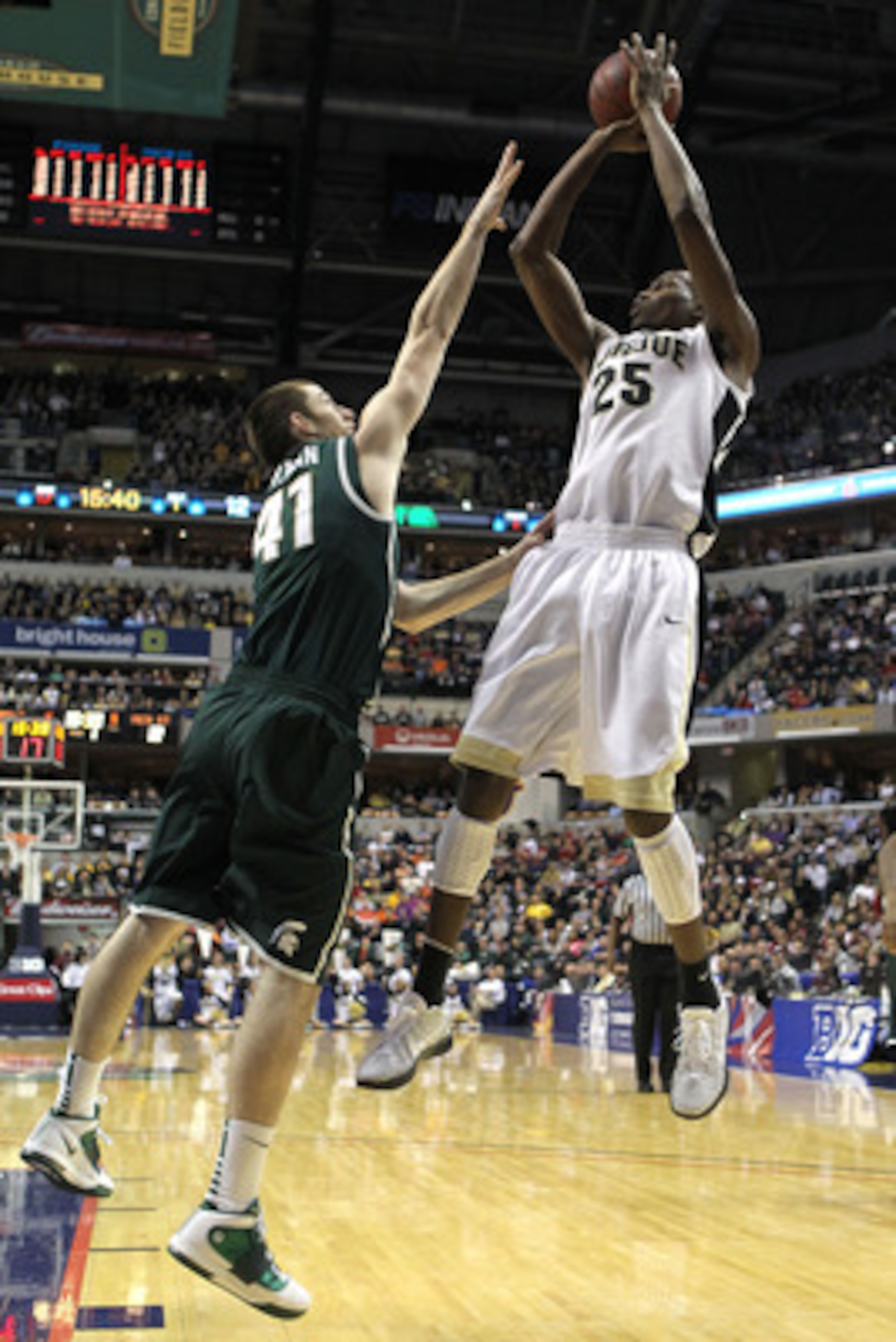 INDIANAPOLIS, IN - MARCH 11:  JaJuan Johnson #25 of the Purdue Boilermakers attempts a shot against Garrick Sherman #41 of the Michigan State Spartans during the quarterfinals of the 2011 Big Ten Men's Basketball Tournament at Conseco Fieldhouse on March 