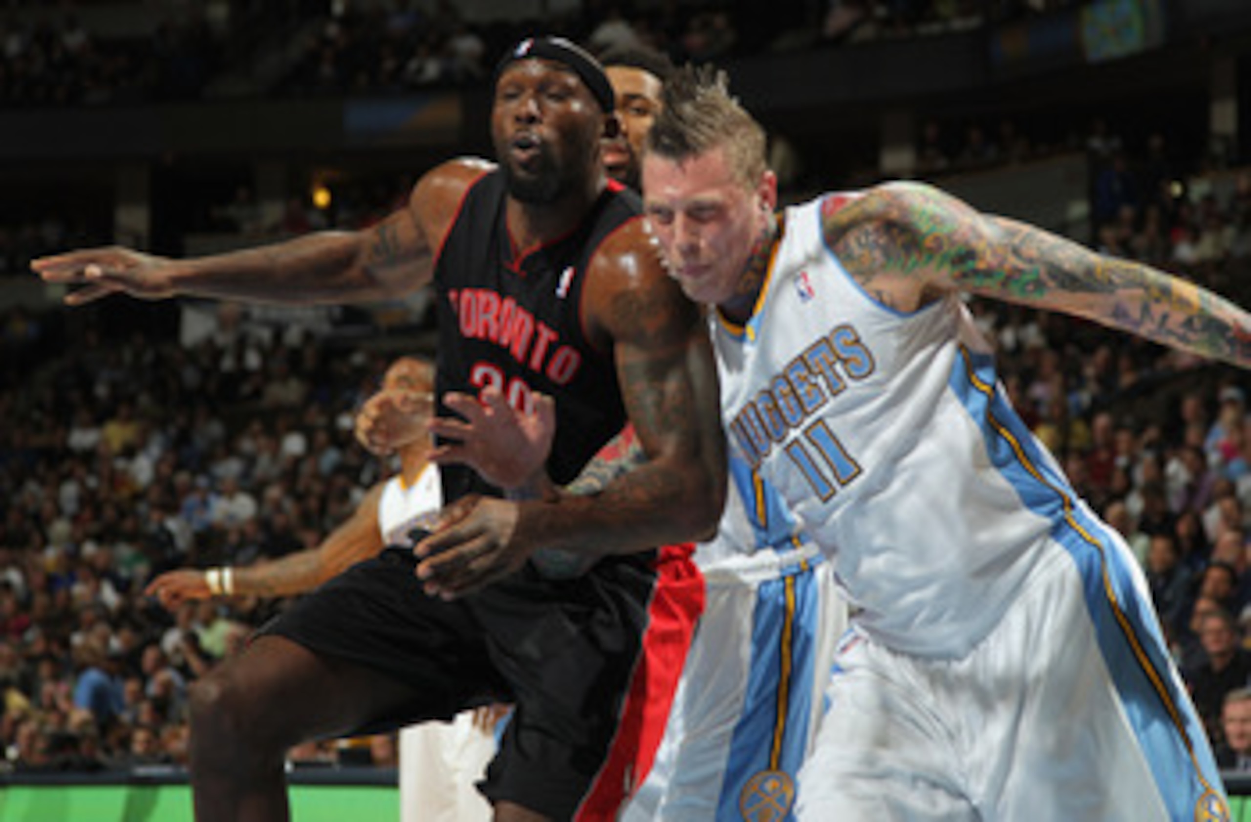 DENVER, CO - MARCH 21:  Chris Andersen #11 of the Denver Nuggets battles for position with Reggie Evans #30 of the Toronto Raptors at the Pepsi Center on March 21, 2011 in Denver, Colorado. NOTE TO USER: User expressly acknowledges and agrees that, by dow