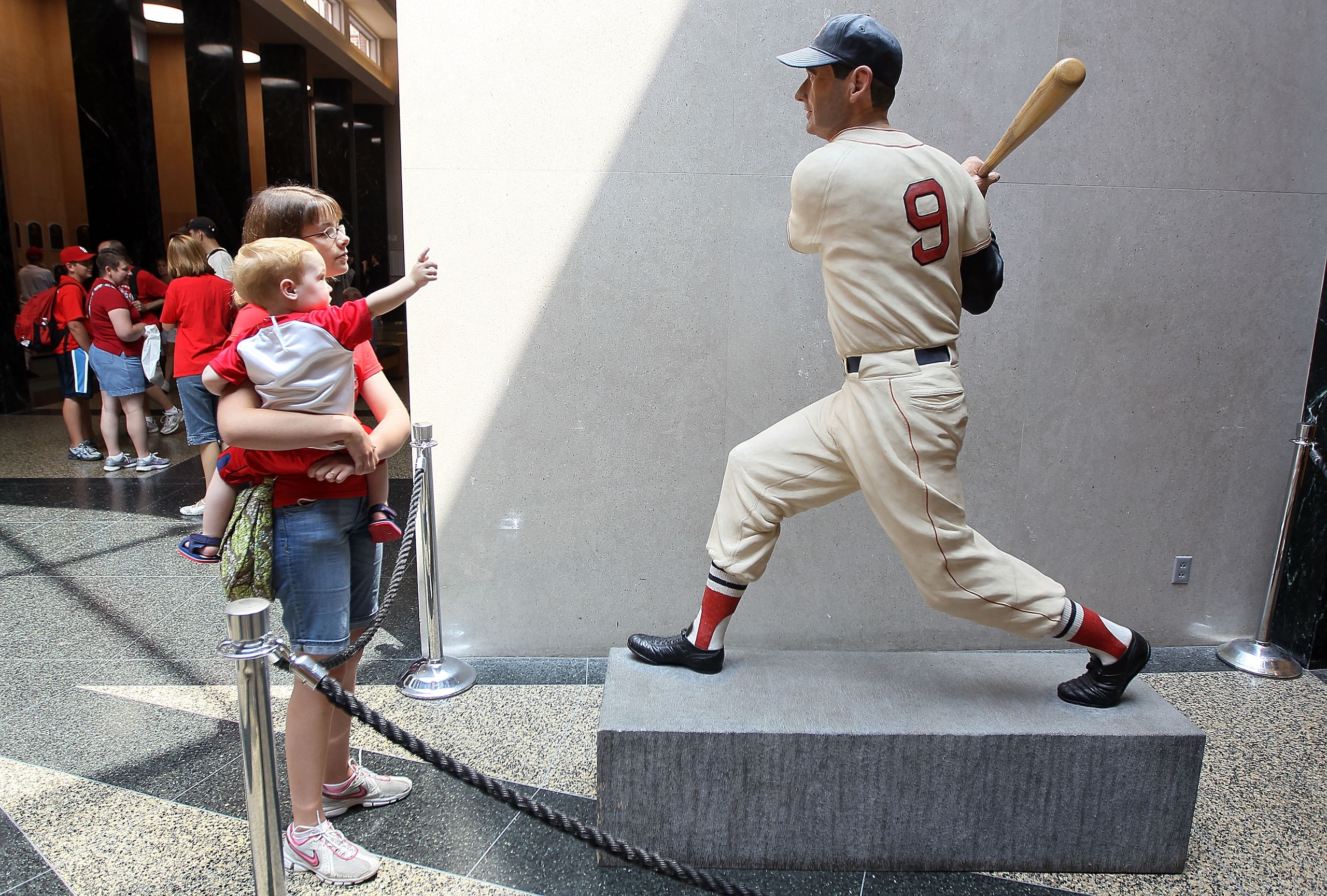 COOPERSTOWN, NY - JULY 24:  Patrons of the Baseball Hall Of Fame and Museum view a statue of Ted Williams during induction weekend on July 24, 2010 in Cooperstown, New York.  (Photo by Jim McIsaac/Getty Images)