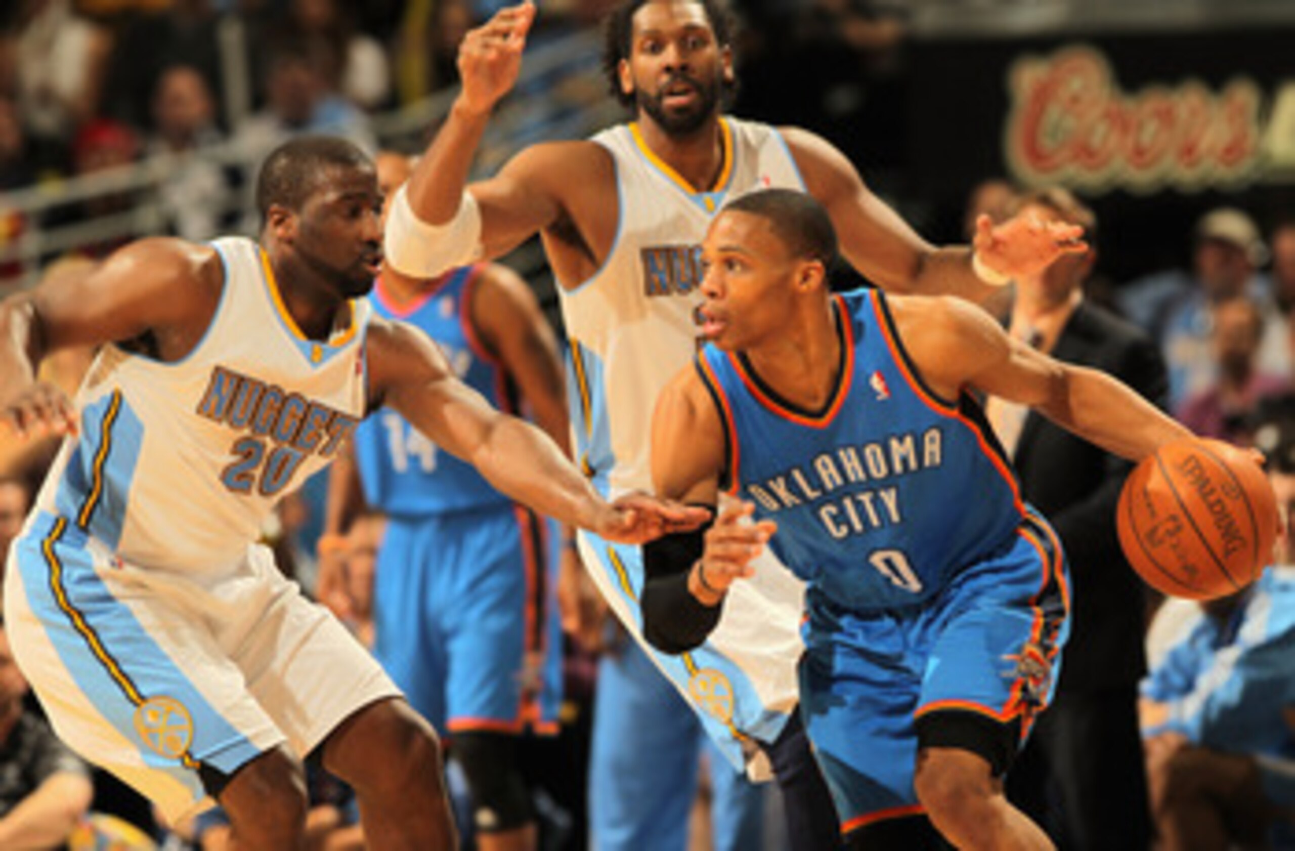DENVER, CO - APRIL 25:  Russell Westbrook #0 of the Oklahoma City Thunder dribbles the ball against Raymond Felton #20 of the Denver Nuggets and Nene Hilario #31 of the Denver Nuggets in Game Four of the Western Conference Quarterfinals in the 2011 NBA Pl