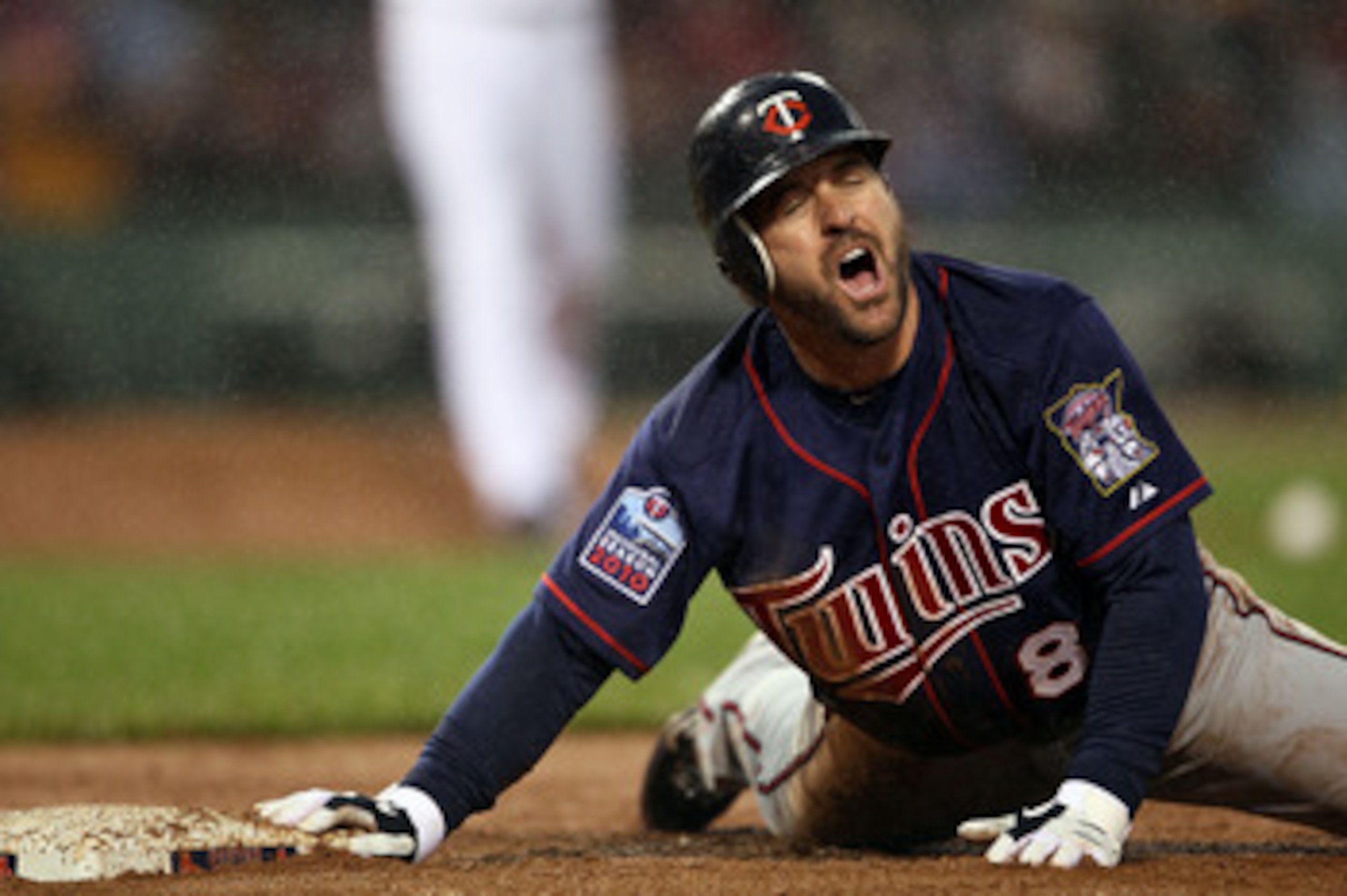 BOSTON - MAY 19:  Nick Punto #8 of the Minnesota Twins reacts after he is picked off at first base in the third inninga against the Boston Red Sox on May 19, 2010 at Fenway Park in Boston, Massachusetts.  (Photo by Elsa/Getty Images)