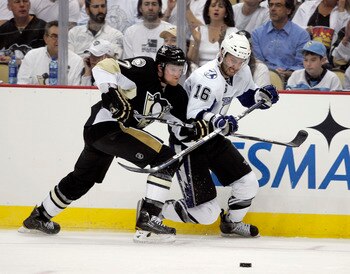 PITTSBURGH, PA - APRIL 27:  Teddy Purcell #16 of the Tampa Bay Lightning battles Paul Martin #7 of the Pittsburgh Penguins for the puck in Game Seven of the Eastern Conference Quarterfinals during the 2011 NHL Stanley Cup Playoffs at Consol Energy Center