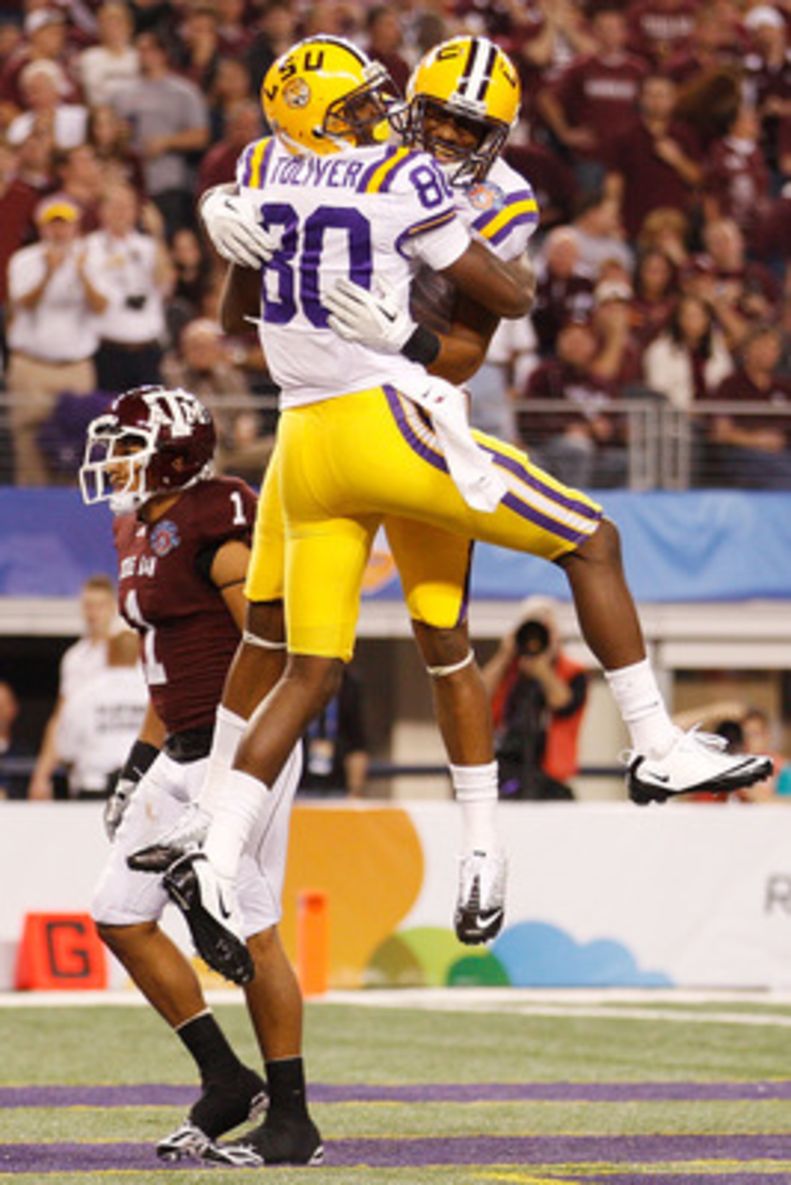 ARLINGTON, TX - JANUARY 07:  Terrence Toliver #80 and Rueben Randle #2 of the Louisiana State University Tigers celebrate after Toliver scored a touchdown against the Texas A&M Aggies during the AT&T Cotton Bowl at Cowboys Stadium on January 7, 2011 in Ar
