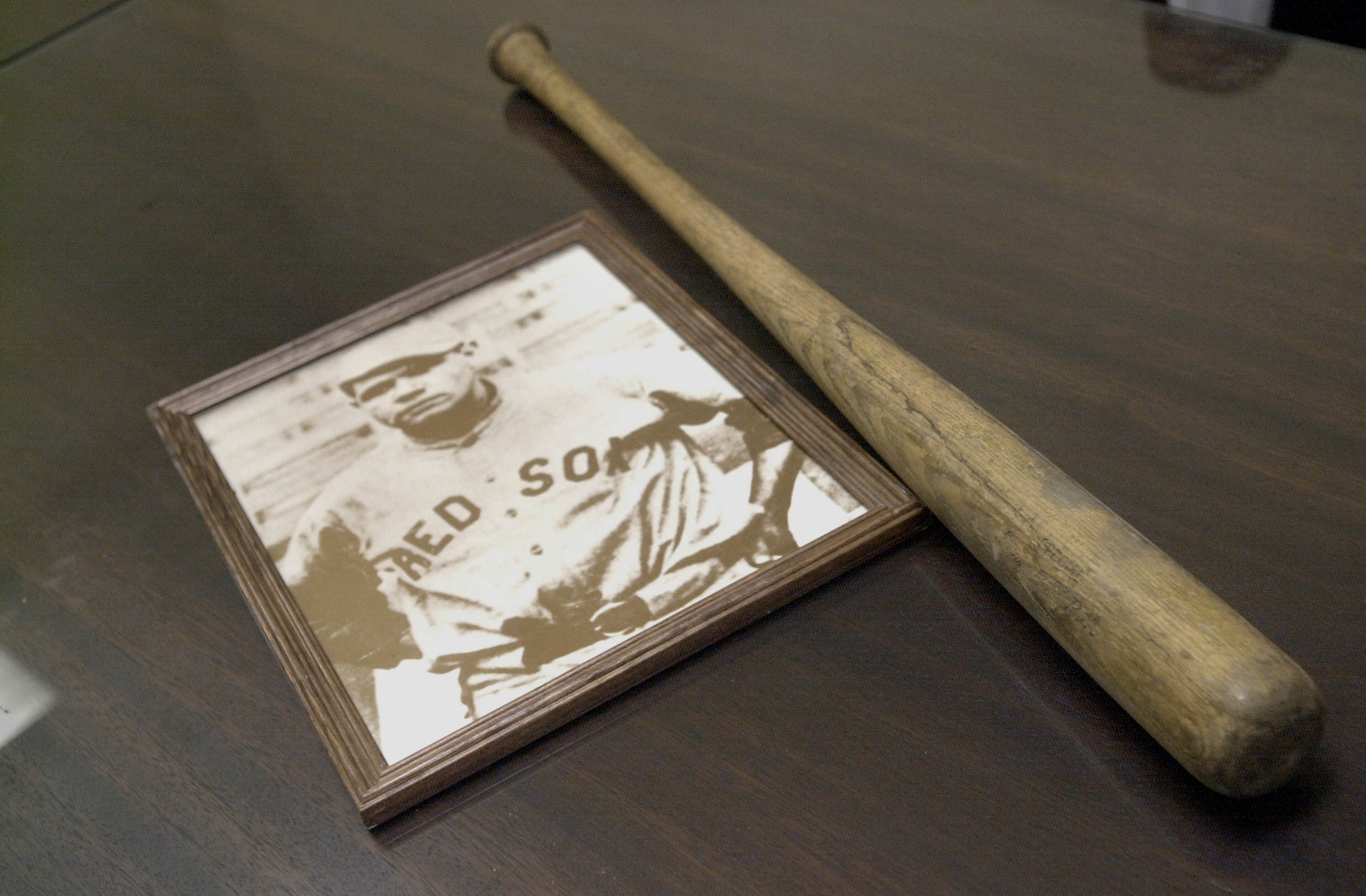 393274 05: A vintage photo and practice bat belonging to legendary ballplayer Herman 'Babe' Ruth sit on a table August 15, 2001 during a press conference to announce a public initiative to honor Ruth in Boston, MA. Ruth led the 1918 Red Sox to a World Ser 393274 05: A vintage photo and practice bat belonging to legendary ballplayer Herman 'Babe' Ruth sit on a table August 15, 2001 during a press conference to announce a public initiative to honor Ruth in Boston, MA. Ruth led the 1918 Red Sox to a World Ser