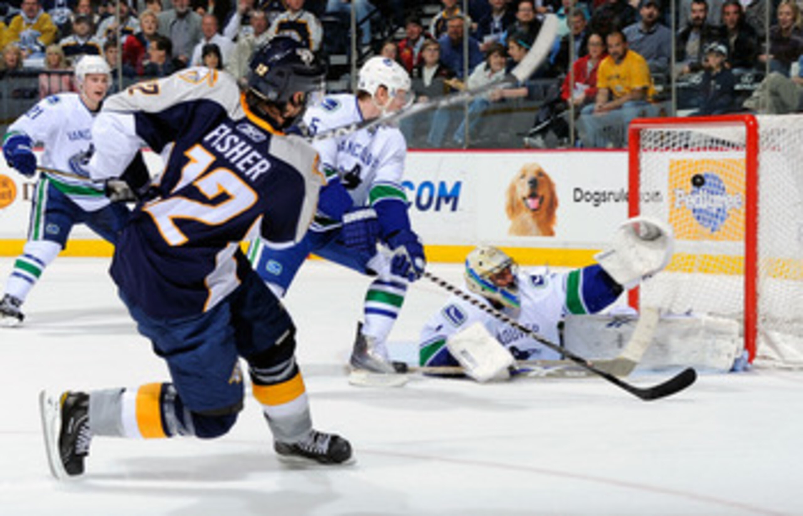 NASHVILLE, TN - MARCH 29:  Mike Fisher #12 of the Nashville Predators scores a goal on Roberto Luongo #1 of the Vancouver Canucks on March 29, 2011 at the Bridgestone Arena in Nashville, Tennessee.  (Photo by Frederick Breedon/Getty Images)