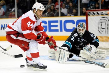 SAN JOSE, CA - MARCH 3: Todd Bertuzzi #44 of the Detroit Red Wings has the puck knocked away by goalie Antti Niemi #31 of the San Jose Sharks in the third period of an NHL hockey game at the HP Pavilion on March 3, 2011 in San Jose, California. The Sharks