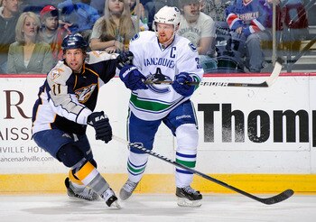 NASHVILLE, TN - MARCH 29:  Henrik Sedin #33 of the Vancouver Canucks skates against David Legwand #11 of the Nashville Predators on March 29, 2011 at the Bridgestone Arena in Nashville, Tennessee.  (Photo by Frederick Breedon/Getty Images)