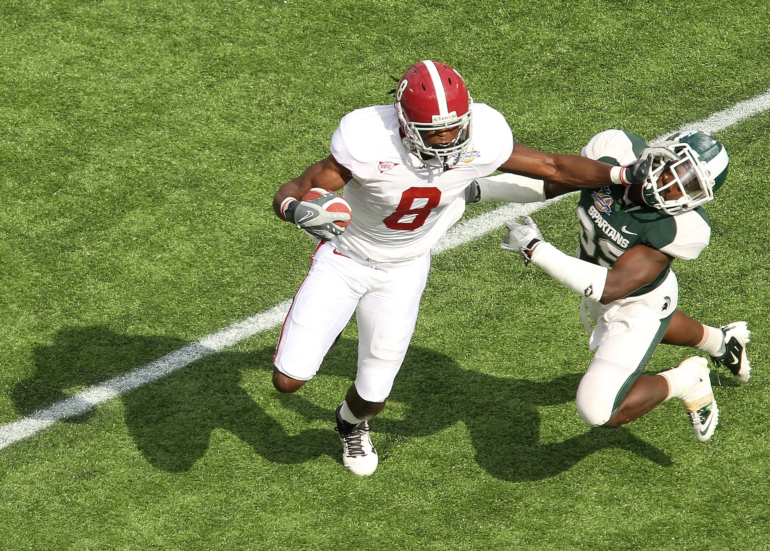 ORLANDO, FL - JANUARY 01: Julio Jones #8 of the Alabama Crimson Tide stiffarms Chris Rucker #29 of the Michigan State Spartans during the Capitol One Bowl at the Florida Citrus Bowl on January 1, 2011 in Orlando, Florida. (Photo by Mike Ehrmann/Getty Im ORLANDO, FL - JANUARY 01: Julio Jones #8 of the Alabama Crimson Tide stiffarms Chris Rucker #29 of the Michigan State Spartans during the Capitol One Bowl at the Florida Citrus Bowl on January 1, 2011 in Orlando, Florida. (Photo by Mike Ehrmann/Getty Im