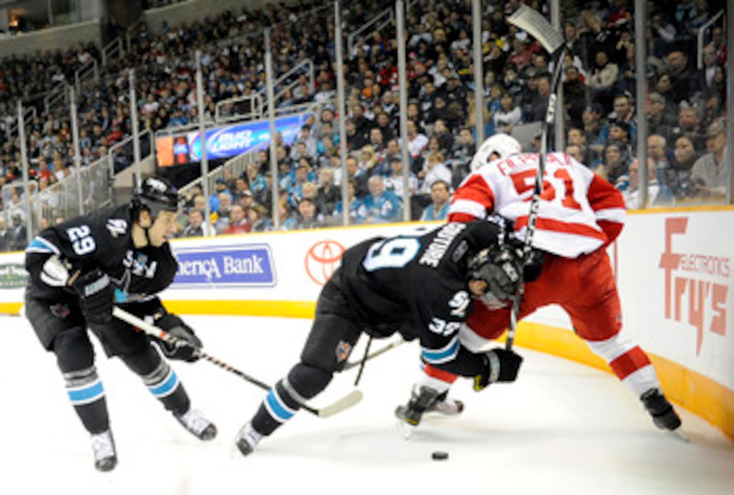 SAN JOSE, CA - MARCH 3: Ryane Clowe #29 and Logan Couture #39 of the San Jose Sharks looks to get the puck away from Valtteri Filppula #51 of the Detroit Red Wings in the second period of an NHL hockey game at the HP Pavilion on March 3, 2011 in San Jose,