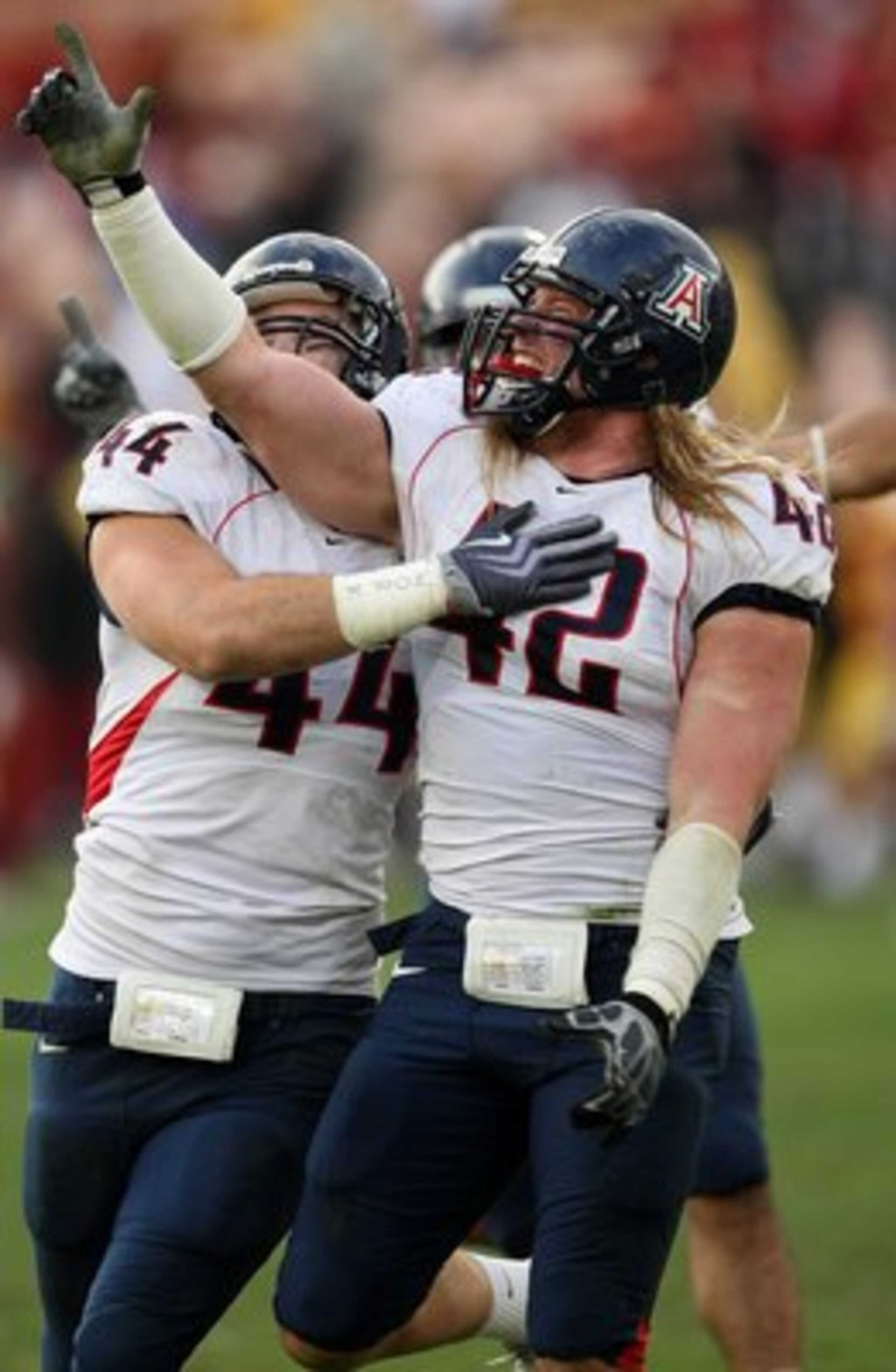 LOS ANGELES, CA - DECEMBER 05:  Defensive ends Brooks Reed #42 and Ricky Elmore #44 of the Arizona Wildcats celebrate after stopping the USC Trojans on the final play on December 5, 2009 at the Los Angeles Coliseum in Los Angeles, California. Arizona won
