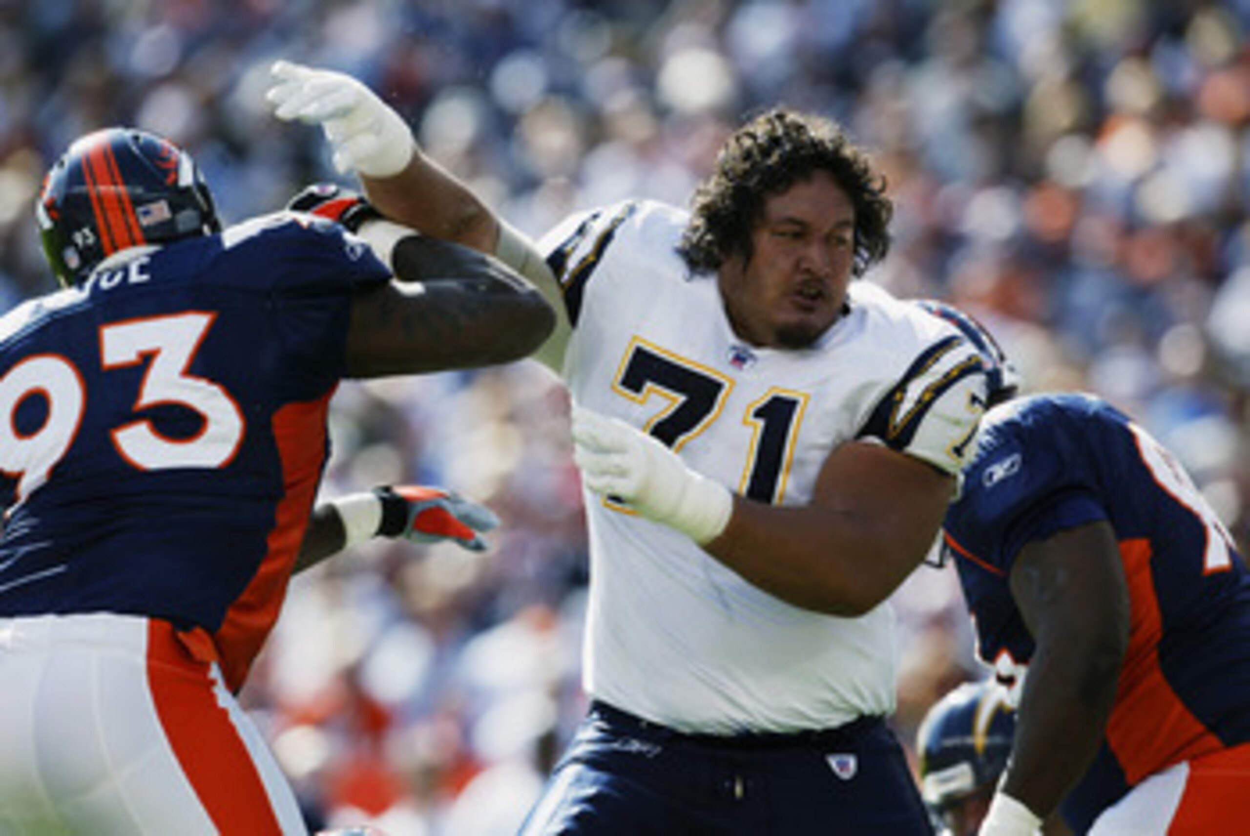 DENVER - OCTOBER 6:  Guard Toniu Fonoti #71 of the San Diego Chargers and defensive end Trevor Pryce #93 of the Denver Broncos struggle for ground in the second quarter of their NFL game on October 6, 2002, at Mile High in Denver, Colorado.  The Broncos w
