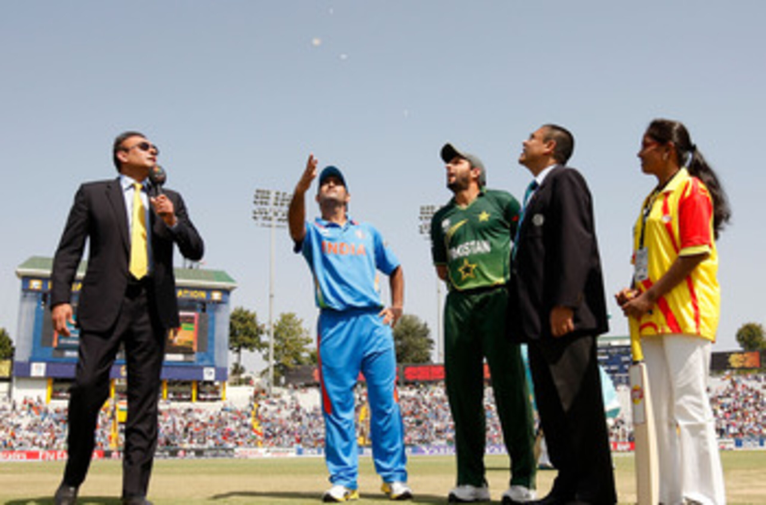 MOHALI, INDIA - MARCH 30: (L-R) Commentator Ravi Shastri, M.S. Dhoni of India, Shahid Afridi of Pakistan ,match referee Ranjan Madugalle and Lays mascot Arancha at the toss during the 2011 ICC World Cup second Semi-Final between Pakistan and India at Punj