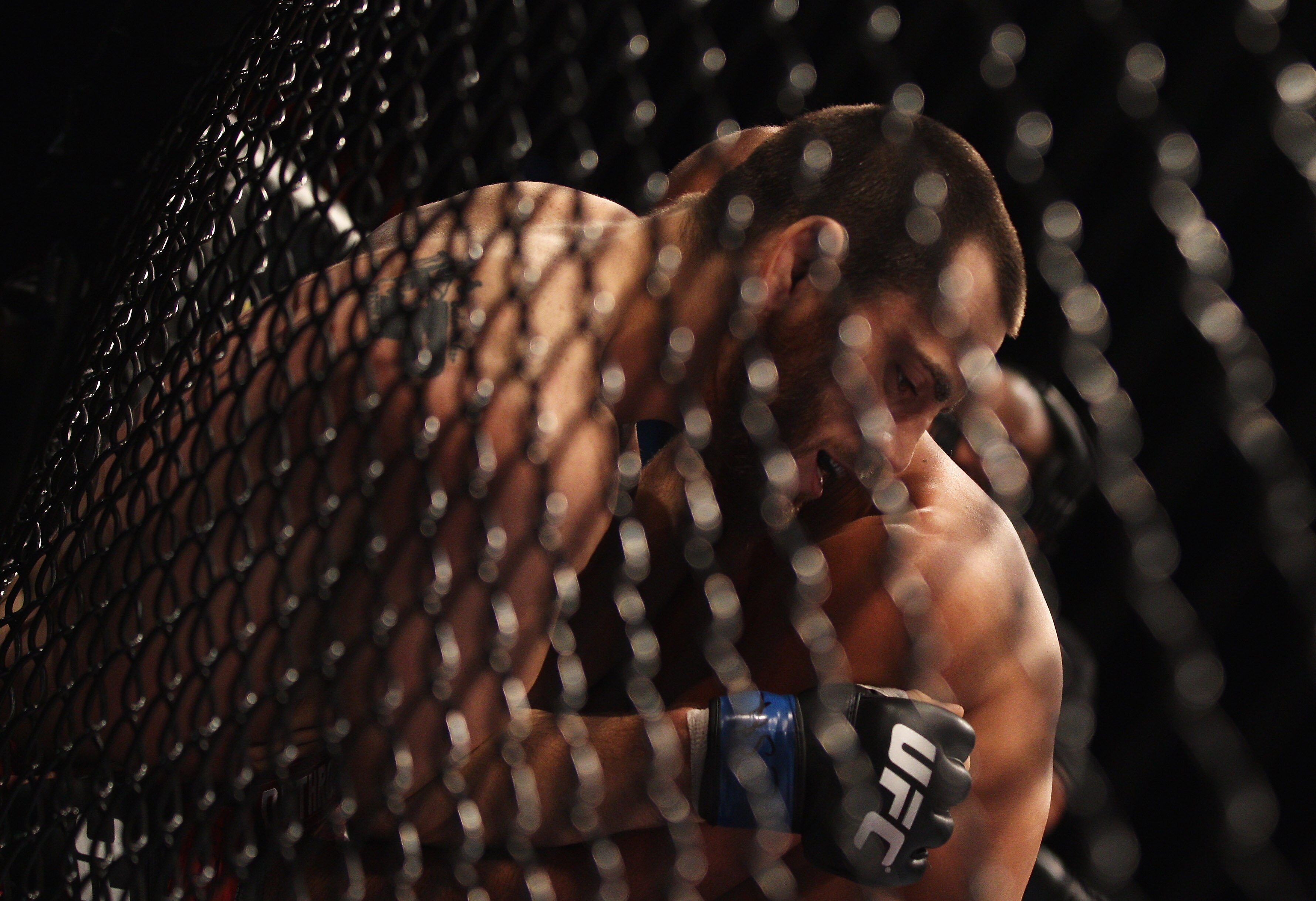 SYDNEY, AUSTRALIA - FEBRUARY 27:  Jon Fitch of the USA is pinned to the cage by BJ Penn of the USA shakes hands at the end of the fight during their welterweight bout part of UFC 127 at Acer Arena on February 27, 2011 in Sydney, Australia.  (Photo by Mark