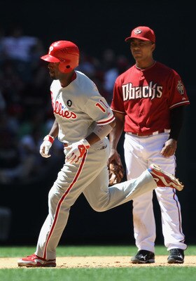 PHOENIX, AZ - APRIL 27:  Jimmy Rollins #11 of the Philadelphia Phillies rounds the bases past infielder Melvin Mora #4 of the Arizona Diamondbacks after Rollins hit a two run home run during the fifth inning of the Major League Baseball game at Chase Fiel