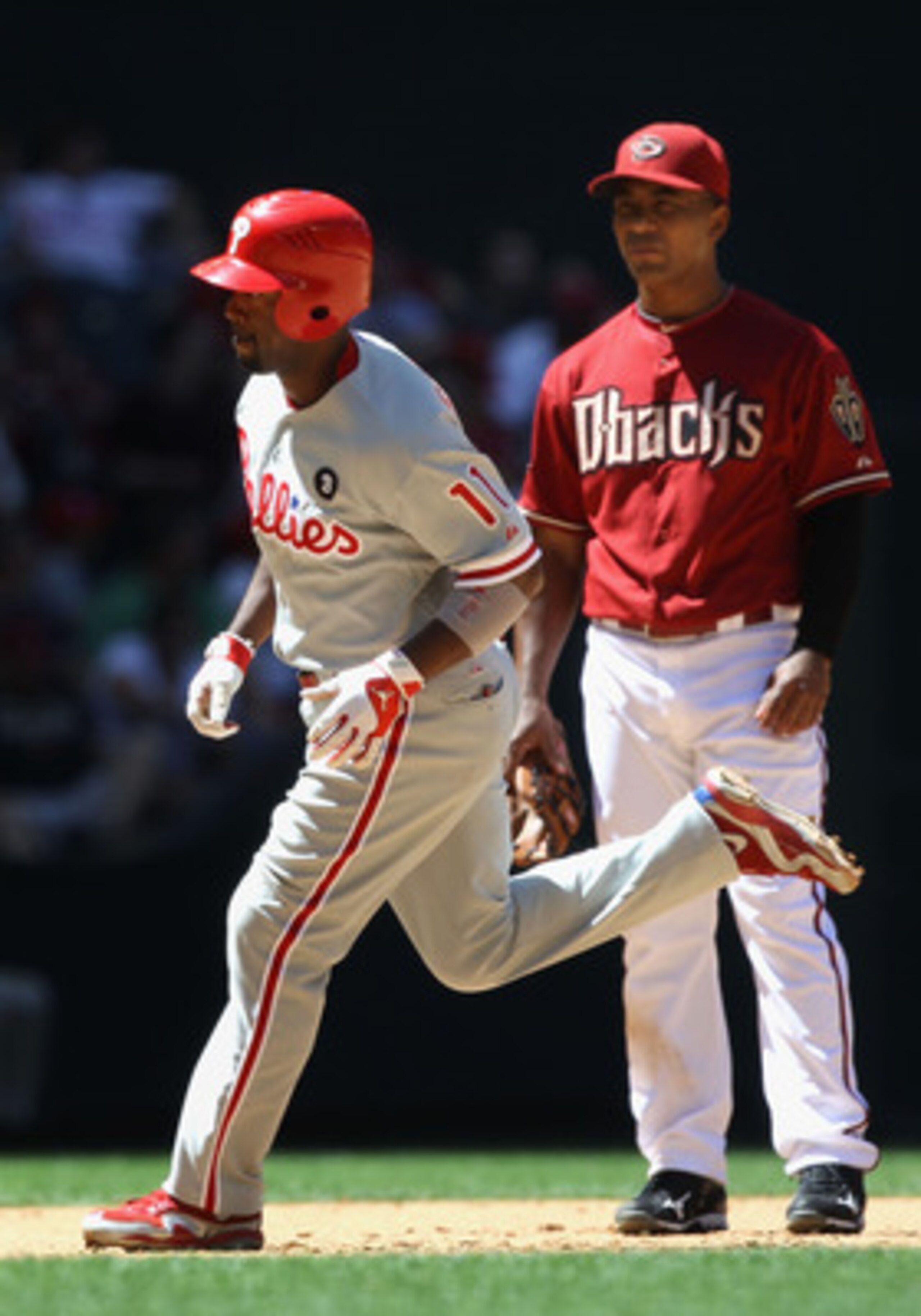 PHOENIX, AZ - APRIL 27:  Jimmy Rollins #11 of the Philadelphia Phillies rounds the bases past infielder Melvin Mora #4 of the Arizona Diamondbacks after Rollins hit a two run home run during the fifth inning of the Major League Baseball game at Chase Fiel