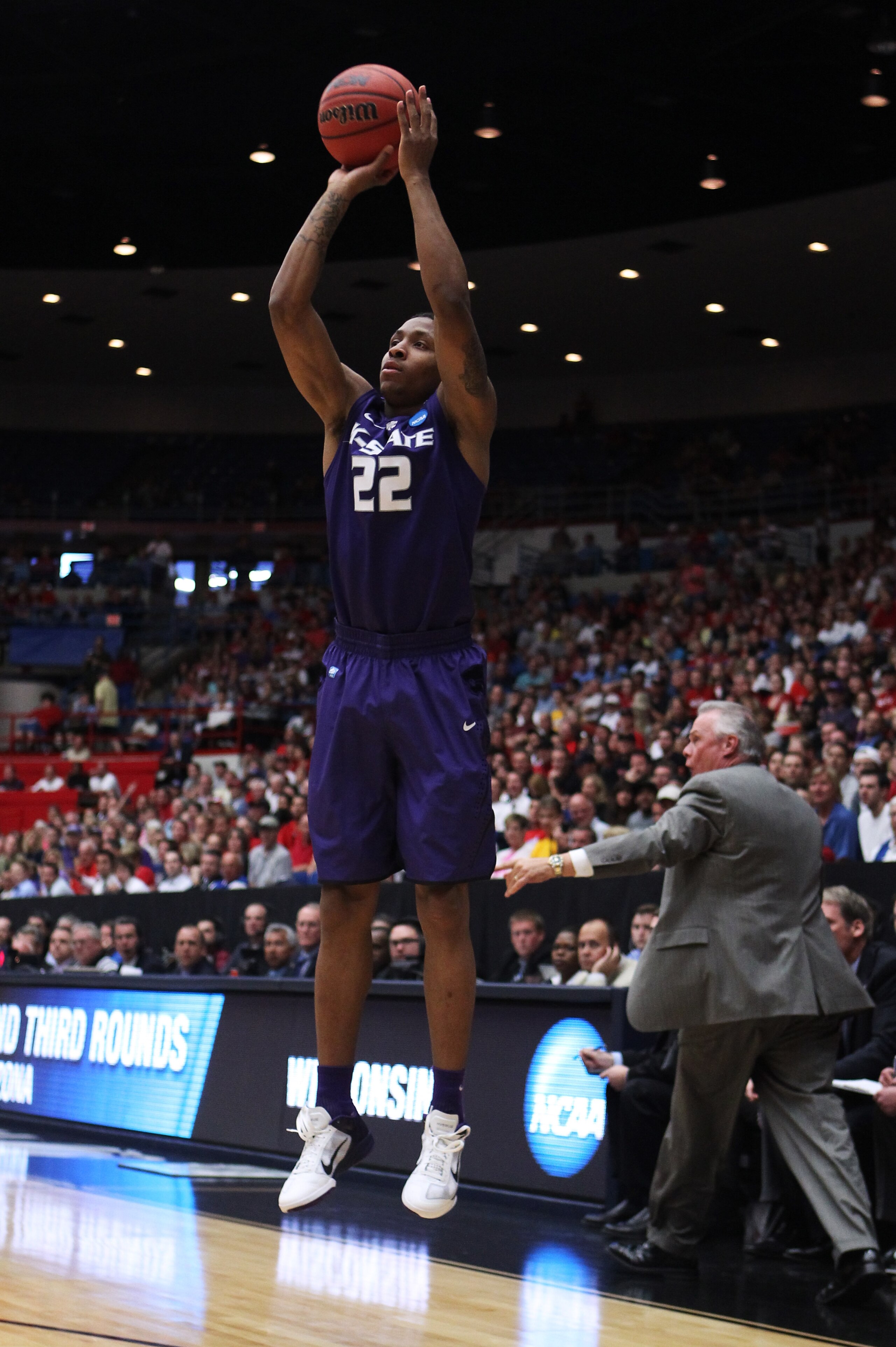 TUCSON, AZ - MARCH 19: Rodney McGruder #22 of the Kansas State Wildcats shoots a three-pointer against the Wisconsin Badgers during the third round of the 2011 NCAA men's basketball tournament at McKale Center on March 19, 2011 in Tucson, Arizona. (Phot TUCSON, AZ - MARCH 19: Rodney McGruder #22 of the Kansas State Wildcats shoots a three-pointer against the Wisconsin Badgers during the third round of the 2011 NCAA men's basketball tournament at McKale Center on March 19, 2011 in Tucson, Arizona. (Phot