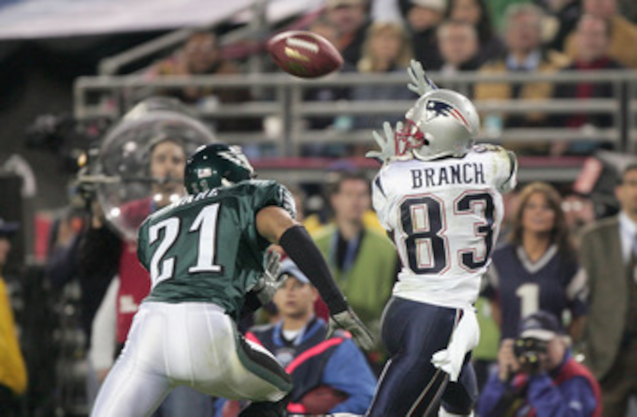 JACKSONVILLE, FL - FEBRUARY 6:  Wide receiver Deion Branch #83 of the New England Patriots receives a pass over Matt Ware #21 of the Philadelphia Eagles during Super Bowl XXXIX at Alltel Stadium on February 6, 2005 in Jacksonville, Florida. The Patriots d
