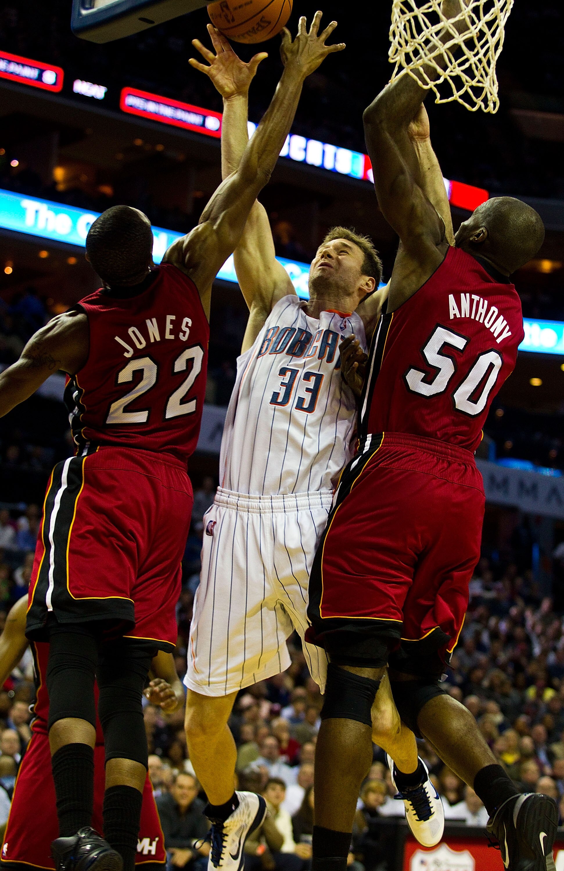 CHARLOTTE, NC - JANUARY 03: Matt Carroll #33 of the Charlotte Bobcats tries to shoot over James Jones #22 and Joel Anthony #50 of the Miami Heat at Time Warner Cable Arena on January 3, 2011 in Charlotte, North Carolina.  The Heat defeated the Bobcats 96-