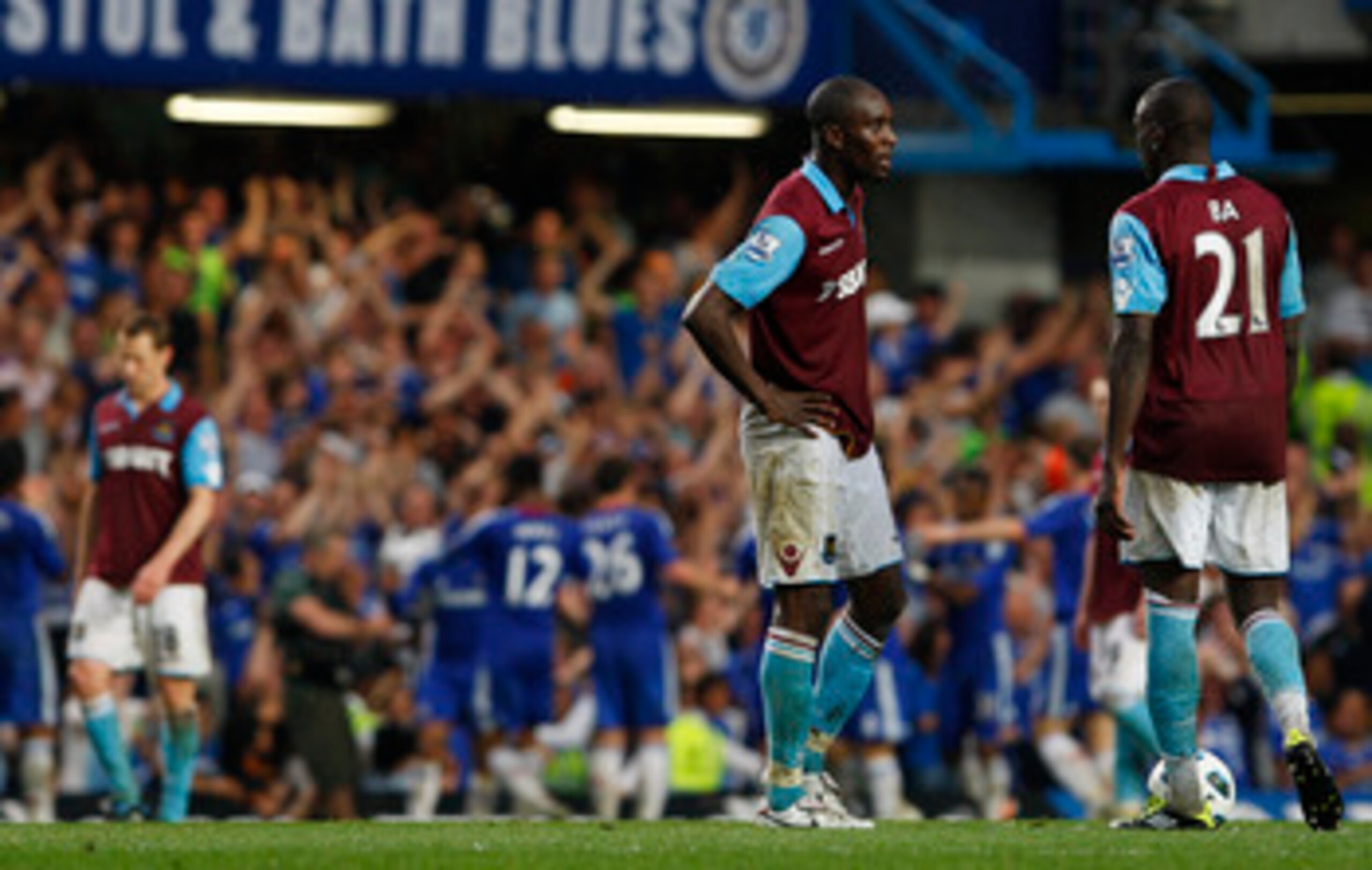 LONDON, ENGLAND - APRIL 23:  Demba Ba (R) and Carlton Cole of West Ham show their dejection as Chelsea players celebrate team mate Frank Lampard's opening goal during the Barclays Premier League match between Chelsea and West Ham United at Stamford Bridge