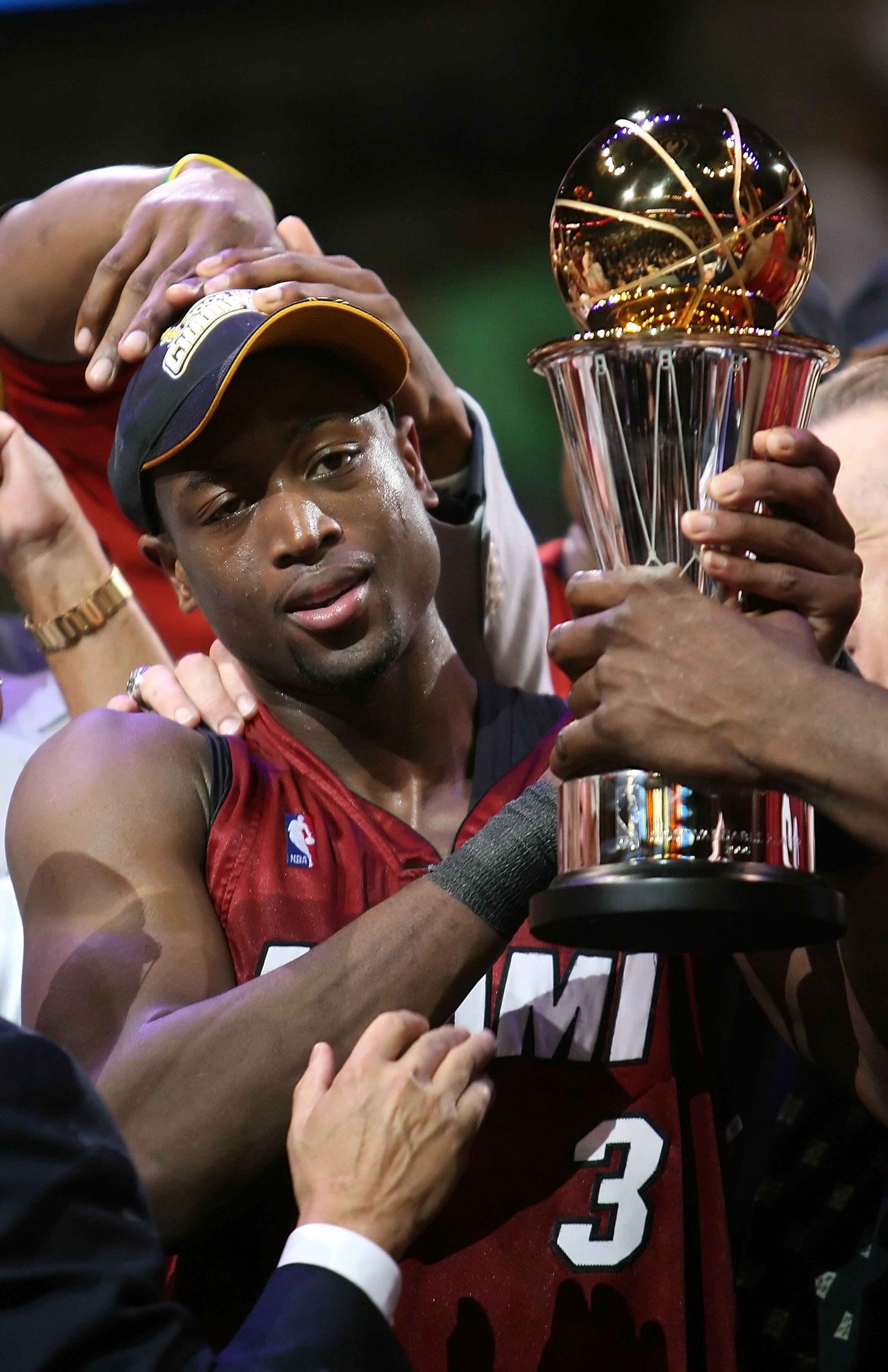 DALLAS - JUNE 20:  Dwyane Wade #3 of the Miami Heat holds up the MVP trophy after the Heat defeated the Dallas Mavericks in game six of the 2006 NBA Finals on June 20, 2006 at American Airlines Center in Dallas, Texas.  The Heat won 95-92 and win the seri