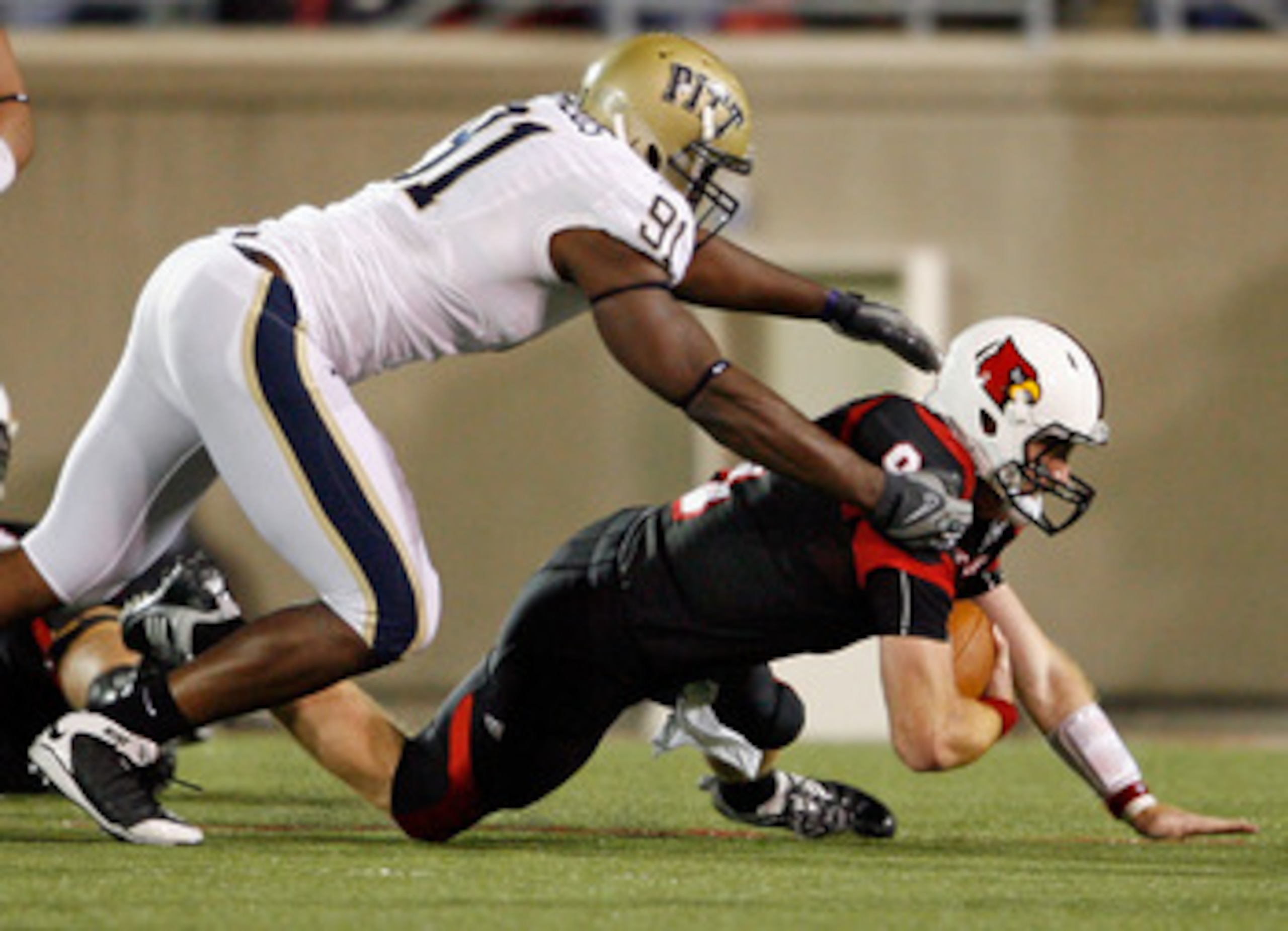 LOUISVILLE, KY - OCTOBER 02: Adam Froman #9 of the Louisville Cardinals is sacked by Greg Romeus #91 of the Pittsburgh Panthers during the Big East Conference game at Papa John's Cardinal Stadium on October 2, 2009 in Louisville, Kentucky. (Photo by An LOUISVILLE, KY - OCTOBER 02: Adam Froman #9 of the Louisville Cardinals is sacked by Greg Romeus #91 of the Pittsburgh Panthers during the Big East Conference game at Papa John's Cardinal Stadium on October 2, 2009 in Louisville, Kentucky. (Photo by An